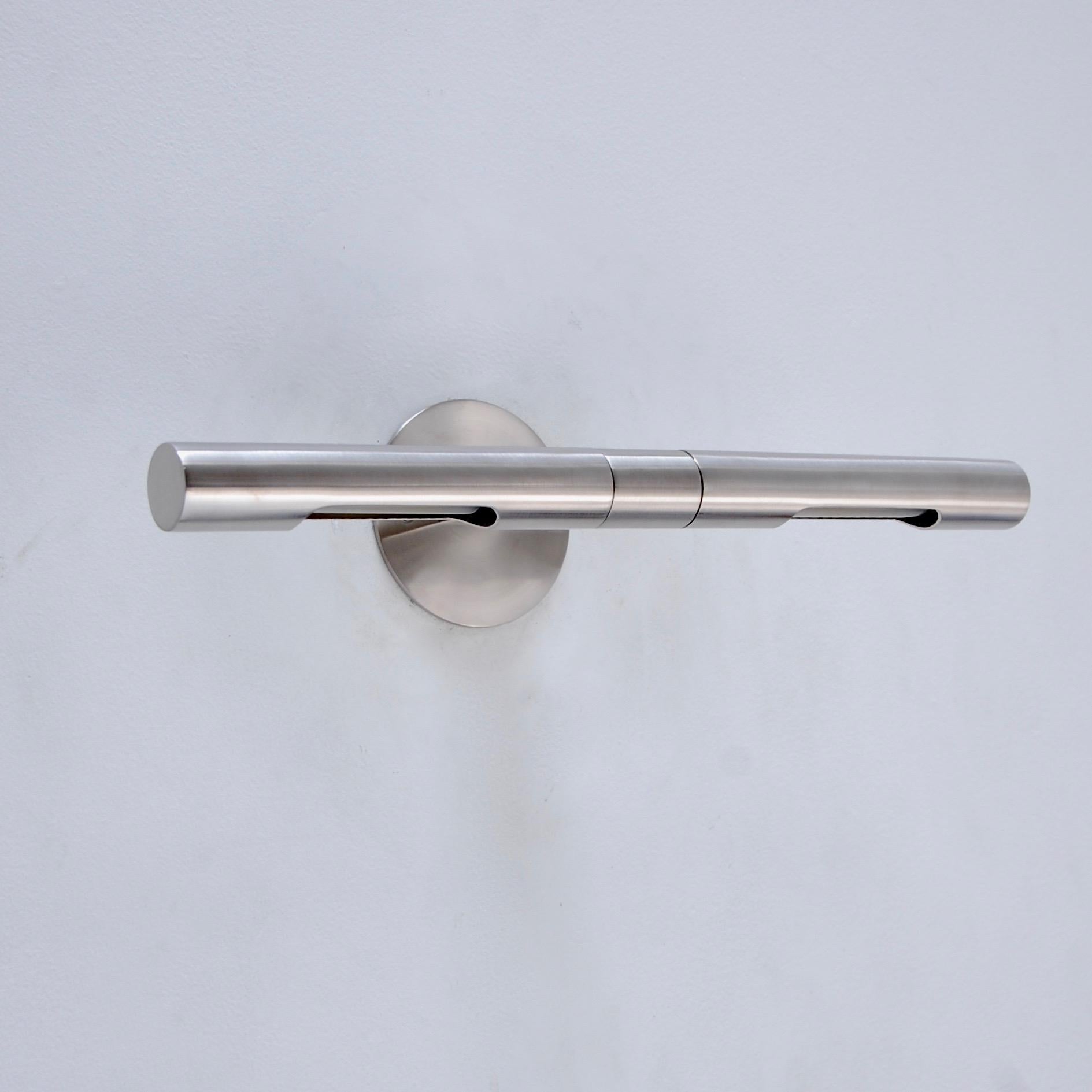 Superbly crafted linear wall sconce designed by Lumfardo Luminaires in a satin nickel finish. Sconce is designed to feature artwork and/or objects d’art. Each shade is independent and can be directed individually. Fixture comes with mounting