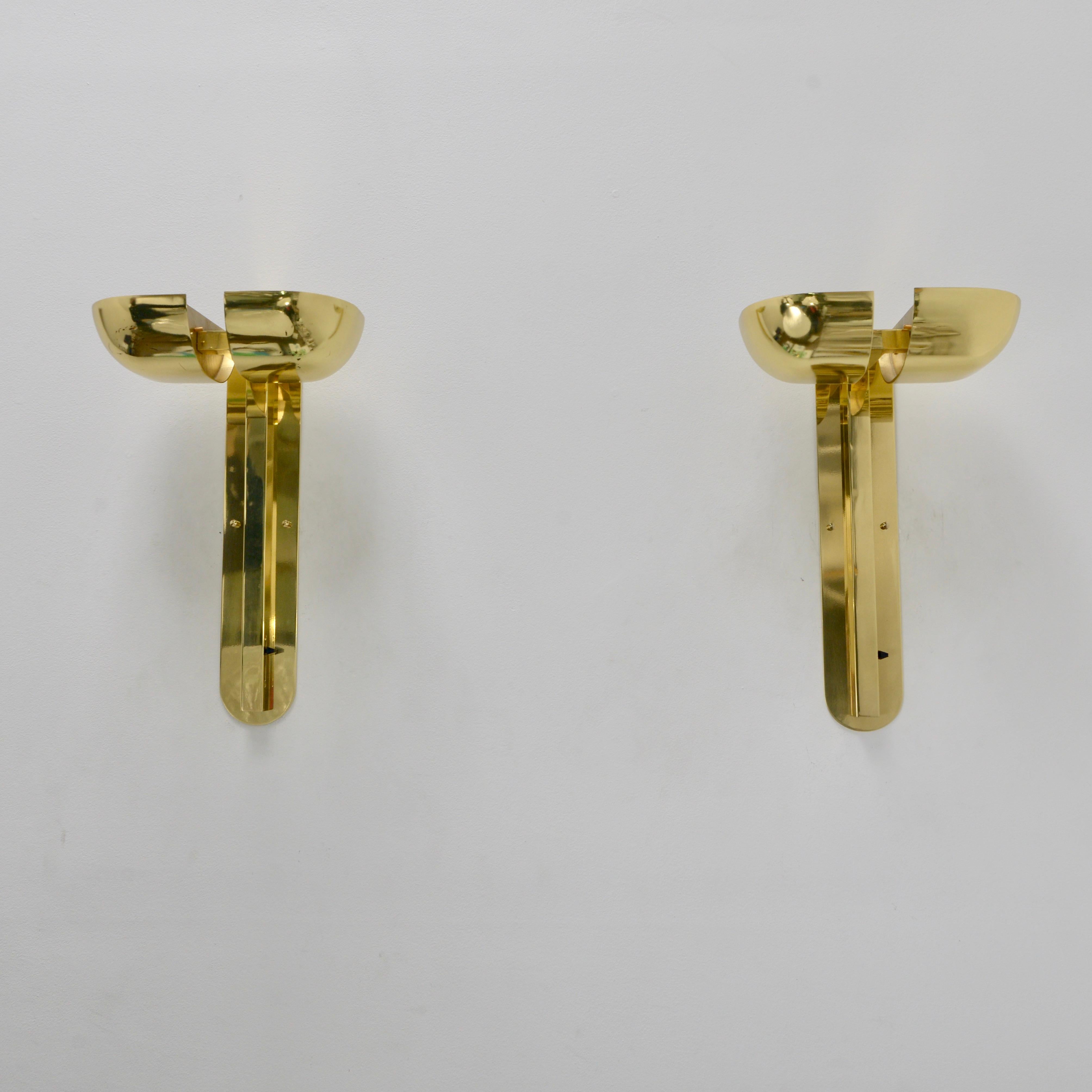Large solid brass directional torchiere wall lamps by Lumi of Italy. Circa 1970s. Naturally aged with minimal wear. Partially restored. Each sconce has 2-E26 medium based light bulbs and a full range dimmer switch. The 2 shades per sconce are