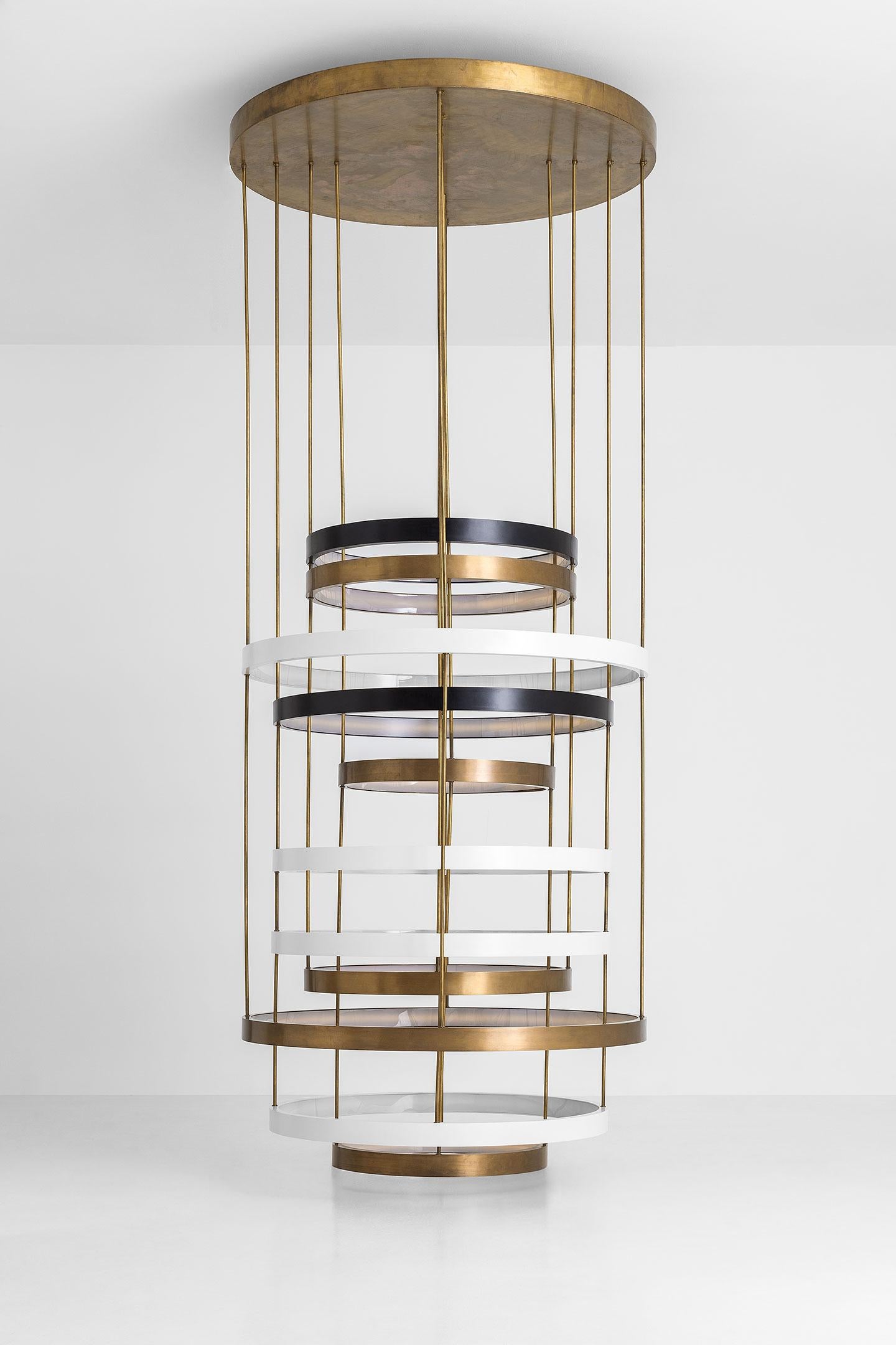 Ceiling lamp with oxidised brass and 11 painted brass rings.
Support tubes in oxidised brass. Light diffusor in opal perspex.
Dimoremilano collection.