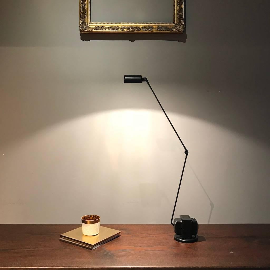 Simple and elegant table lamp designed by Tommaso Cimini for Lumina, Italy in 1975. The lamp is made of metal with an articulated arm and a diffuser pivoting on 360°. Fully working and tested condition. Halogen 230V. 
Since 1975 this lamp has