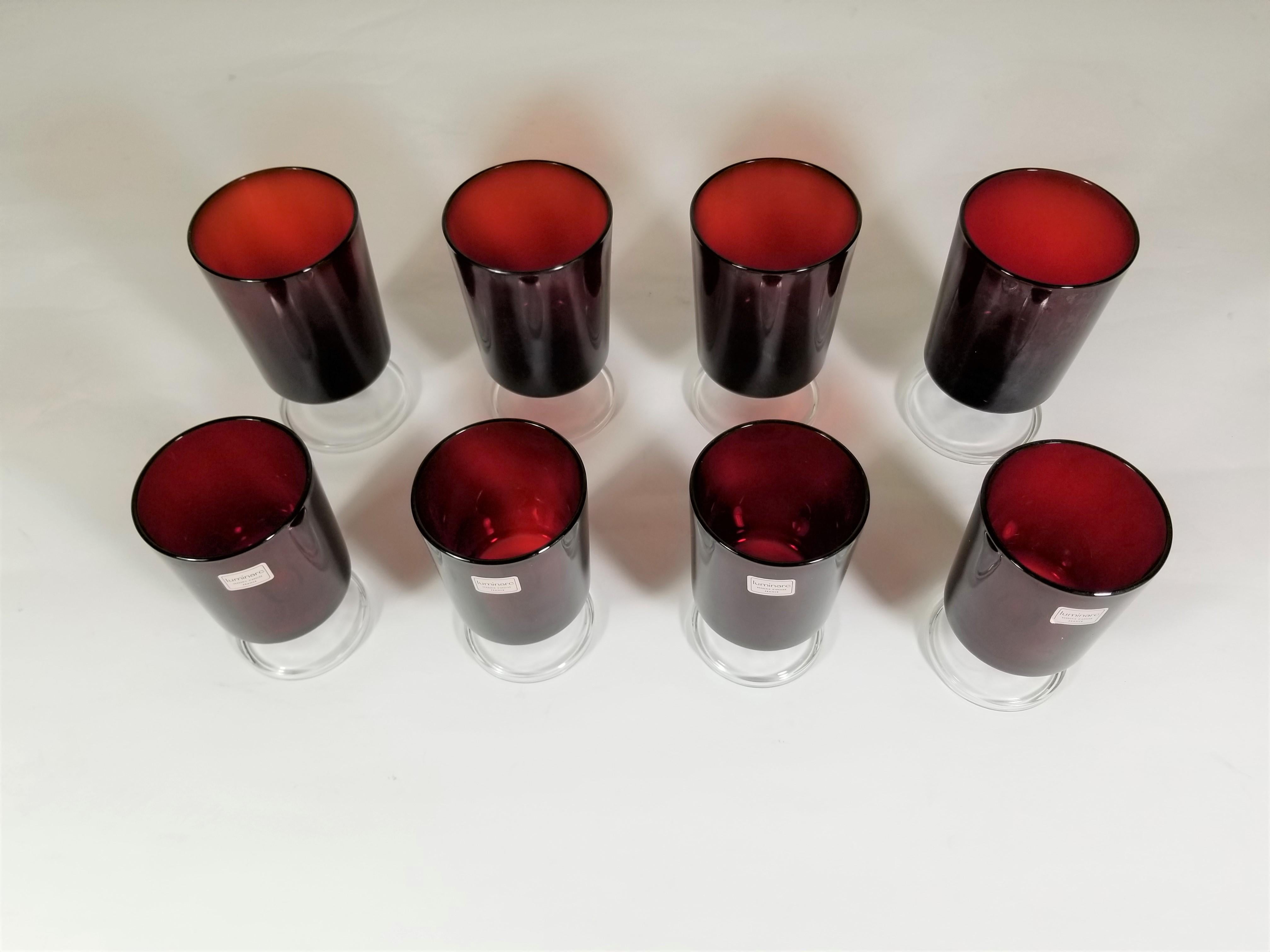 Gorgeous set of midcentury 1960s glassware Made in France. Ruby red glasses with clear glass stems. Total of 8. 4 large and 4 medium sized glasses. Excellent new condition. Still retains original marking stickers. All glasses marked France on
