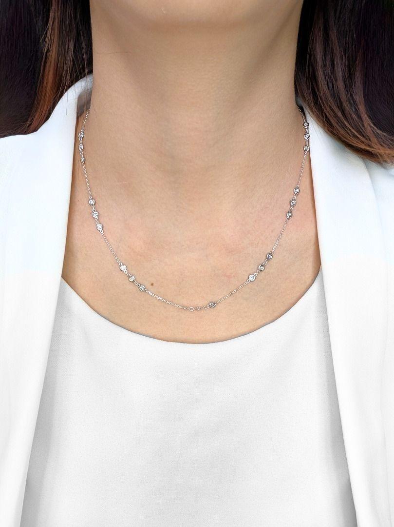 This pre-owned necklace offers a substantial sparkle with its array of thirty brilliant-cut natural diamonds. Together, these diamonds weigh an impressive 1.5 carats and exhibit a beautiful F-G color grade, appearing near-colorless, along with a