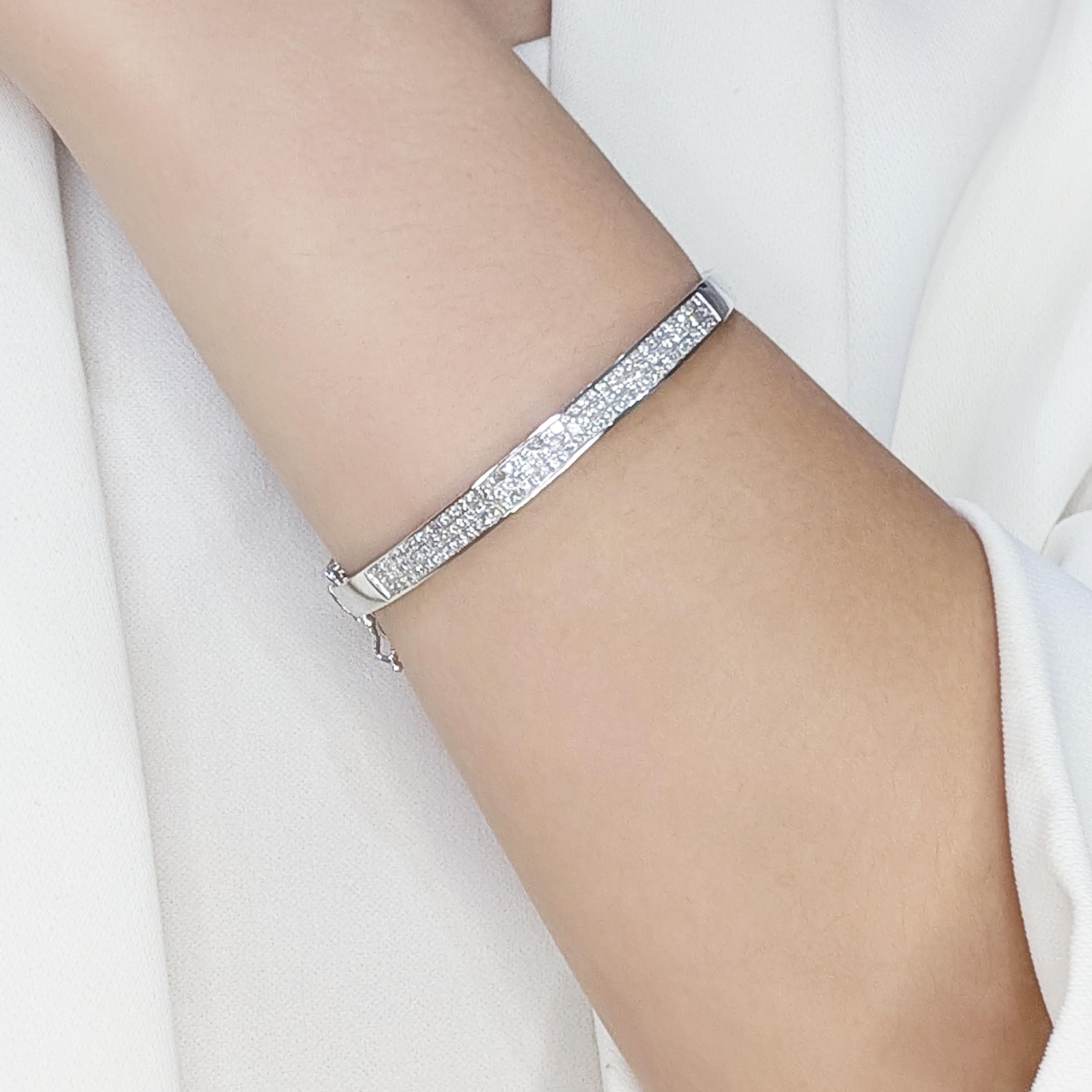 Make a statement of luxury with this brand-new bangle, meticulously crafted in luminous 18K white gold. This exquisite piece is adorned with 120 princess-cut natural diamonds, boasting a remarkable total carat weight of 1.74ct. Graded G-H for color