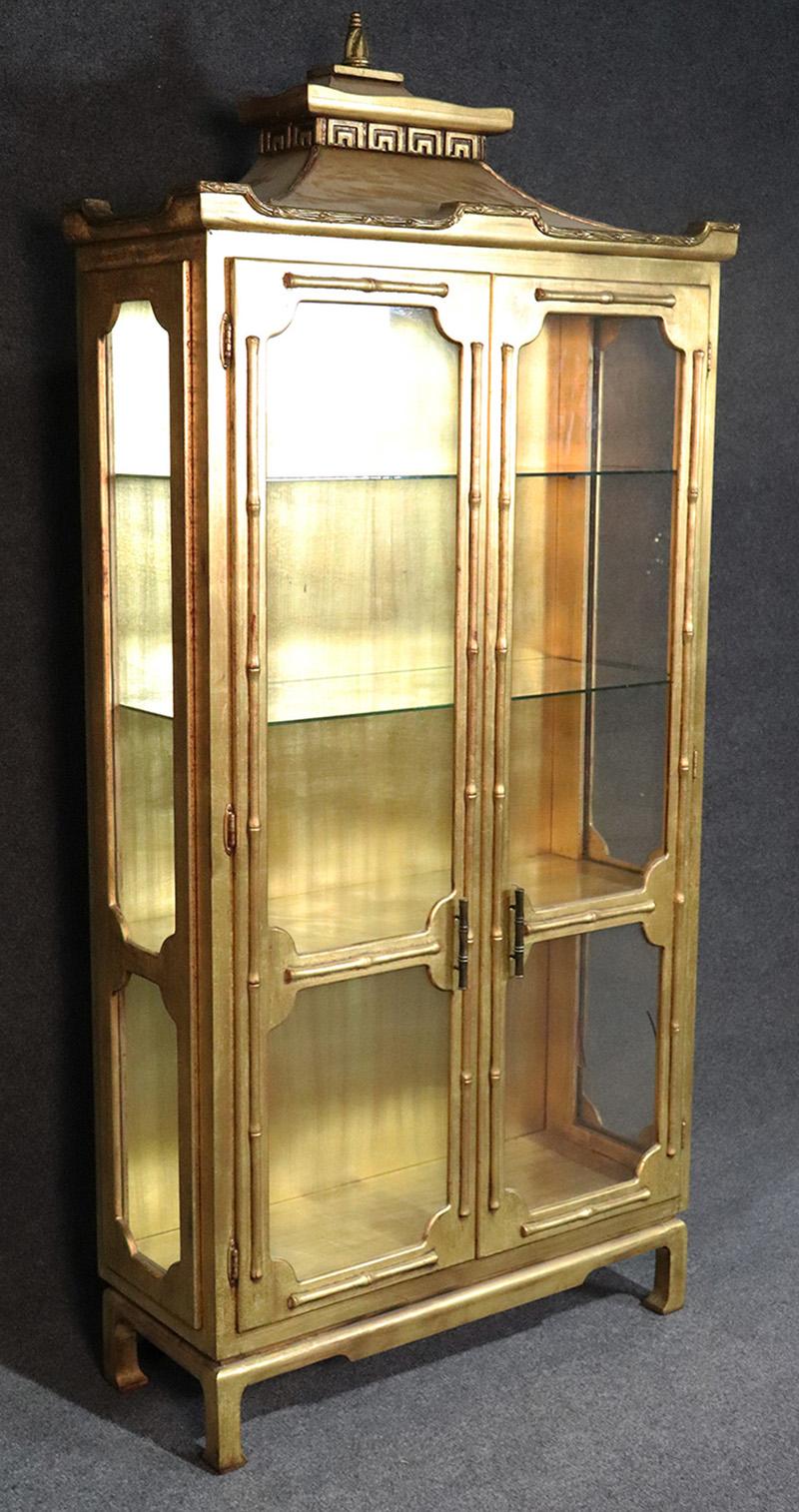 This is a glamorous and decadently designed cabinet! Layered in pure gold leaf, real gold, not paint! This cabinet cost a lot of money to make and it's lighted with glass shelves so not only can you display with beauty, you can display beautiful