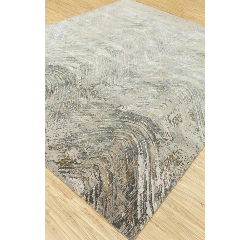 Have you ever imagined bringing the serene hues of rural landscapes into your modern living space? The contemporary rug from the Gauri Khan collection - Tattvam, invites you to do just that. Hand-knotted with meticulous care in rural India, each