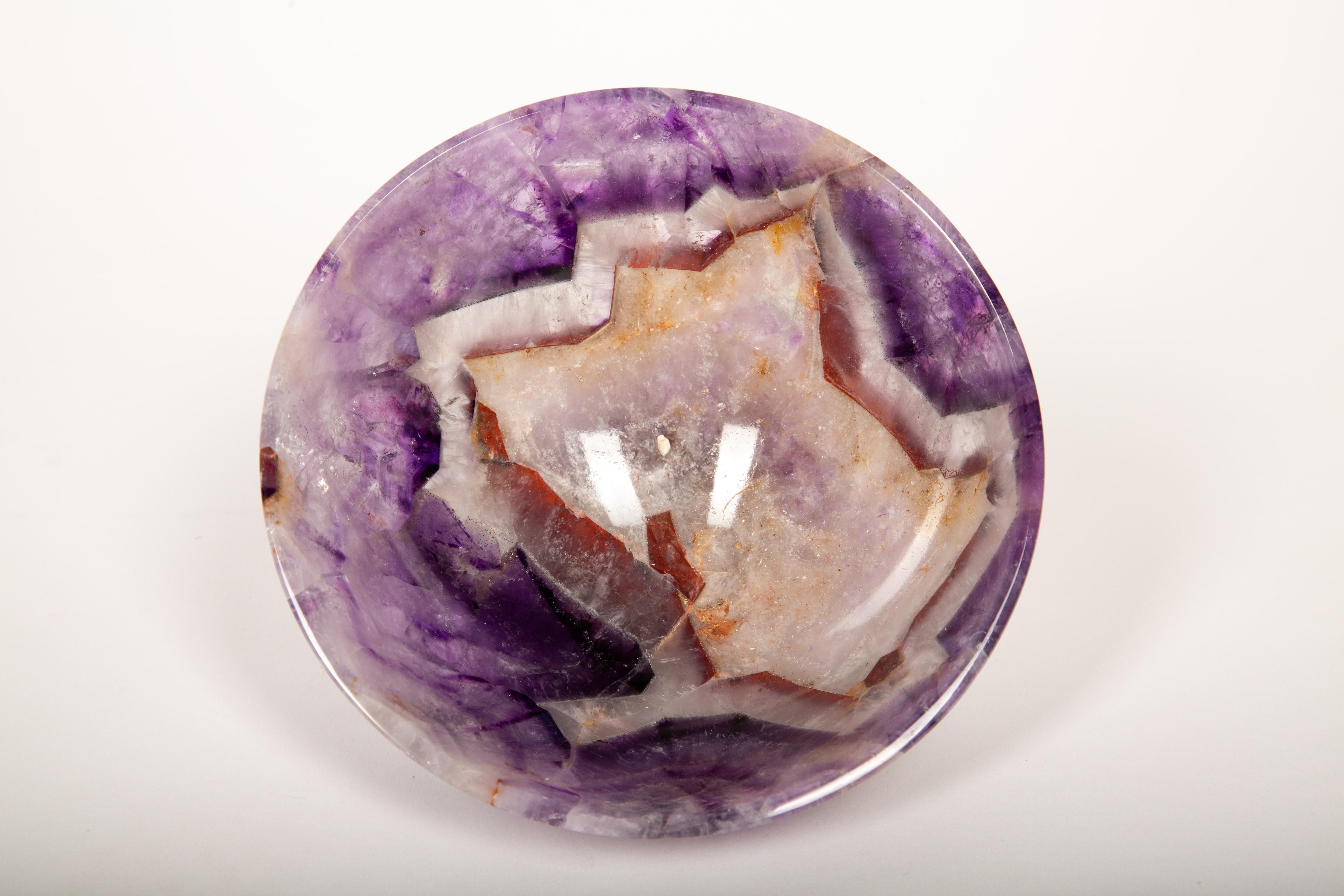 A breathtaking fusion of nature and craftsmanship, this exquisite hand-carved amethyst bowl is a true work of art. Measuring 6 inches in diameter, it is meticulously shaped and polished by skilled artisans in India, where the tradition of stone