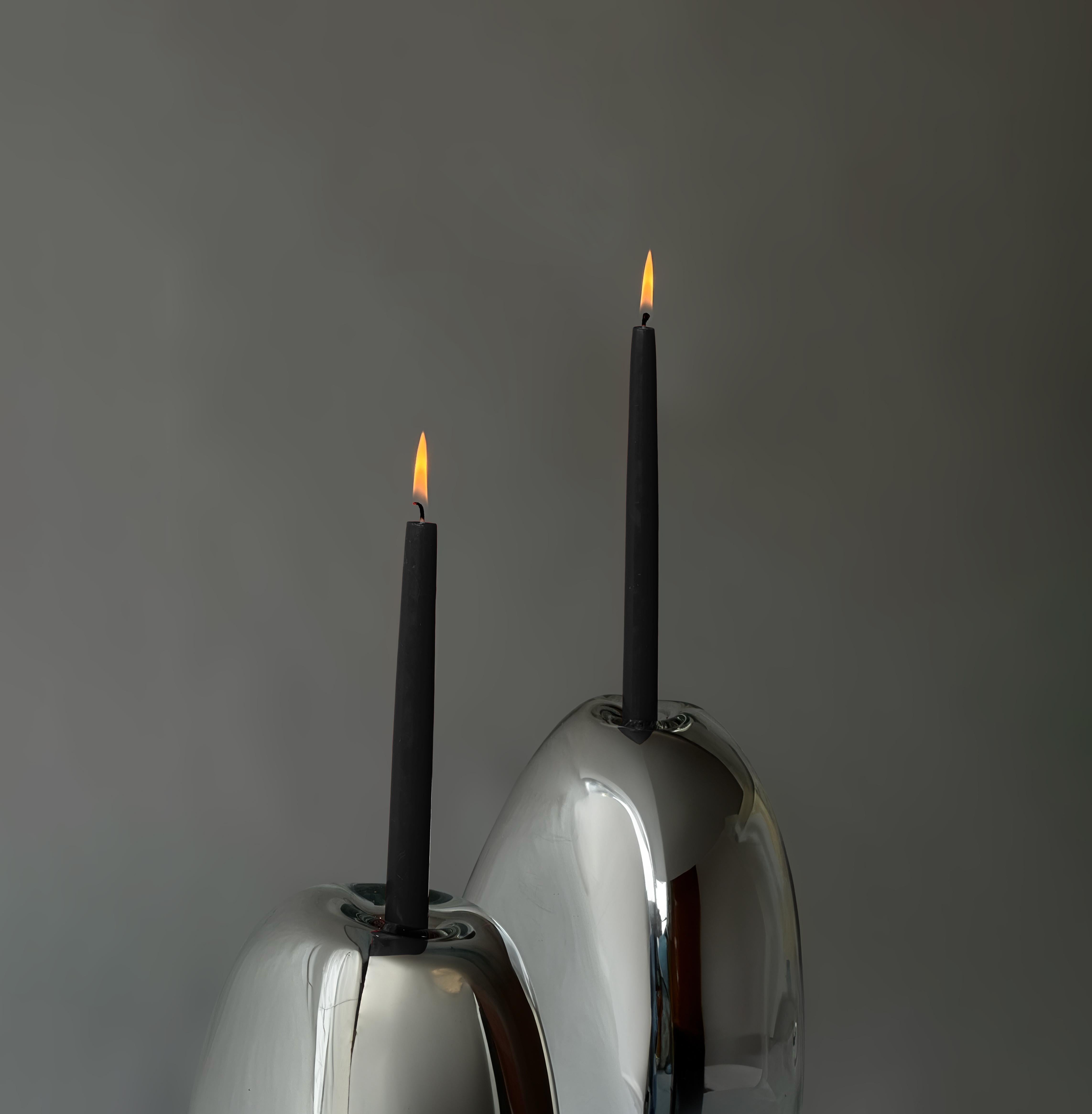 Blown Glass. Silver Mirror or Smoke Mirror.

Molten glass is an incredibly malleable material. It is viscous enough to be blown and gradually hardens as it loses heat. As the glass cools, it finds its form through intervention by an external force.