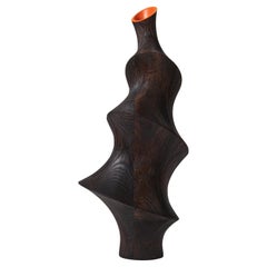 Lun 0.2, a dark ash ridged wooden sculpture with orange interior by Donald Baugh