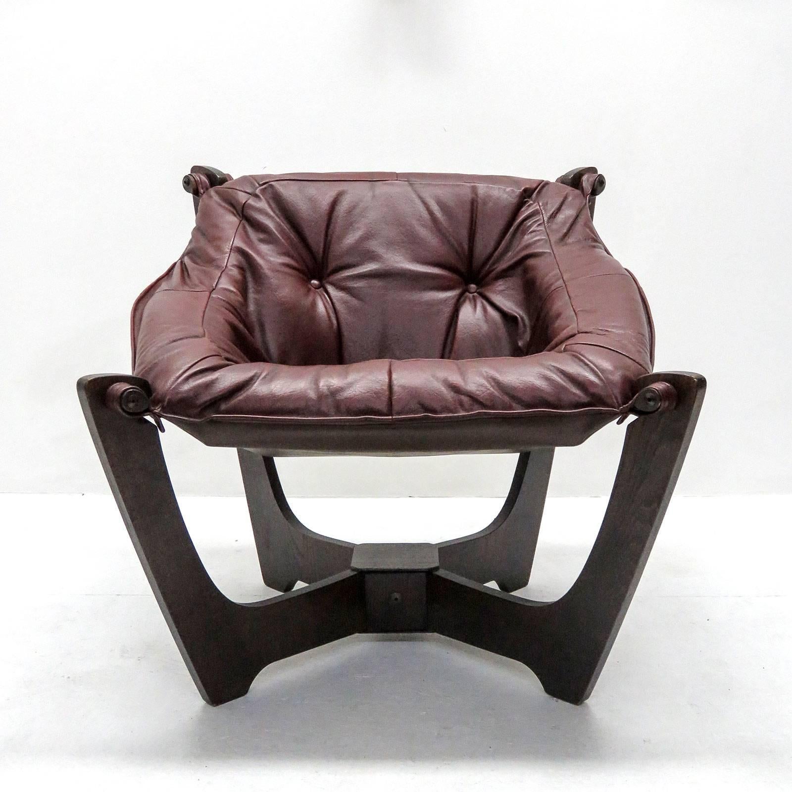 Wonderful 'Luna' armchair by Odd Knutsen for Hjellegjerde, frame of dark stained wood, mounted with oxblood semi-aniline leather seat produced in the 1970s.