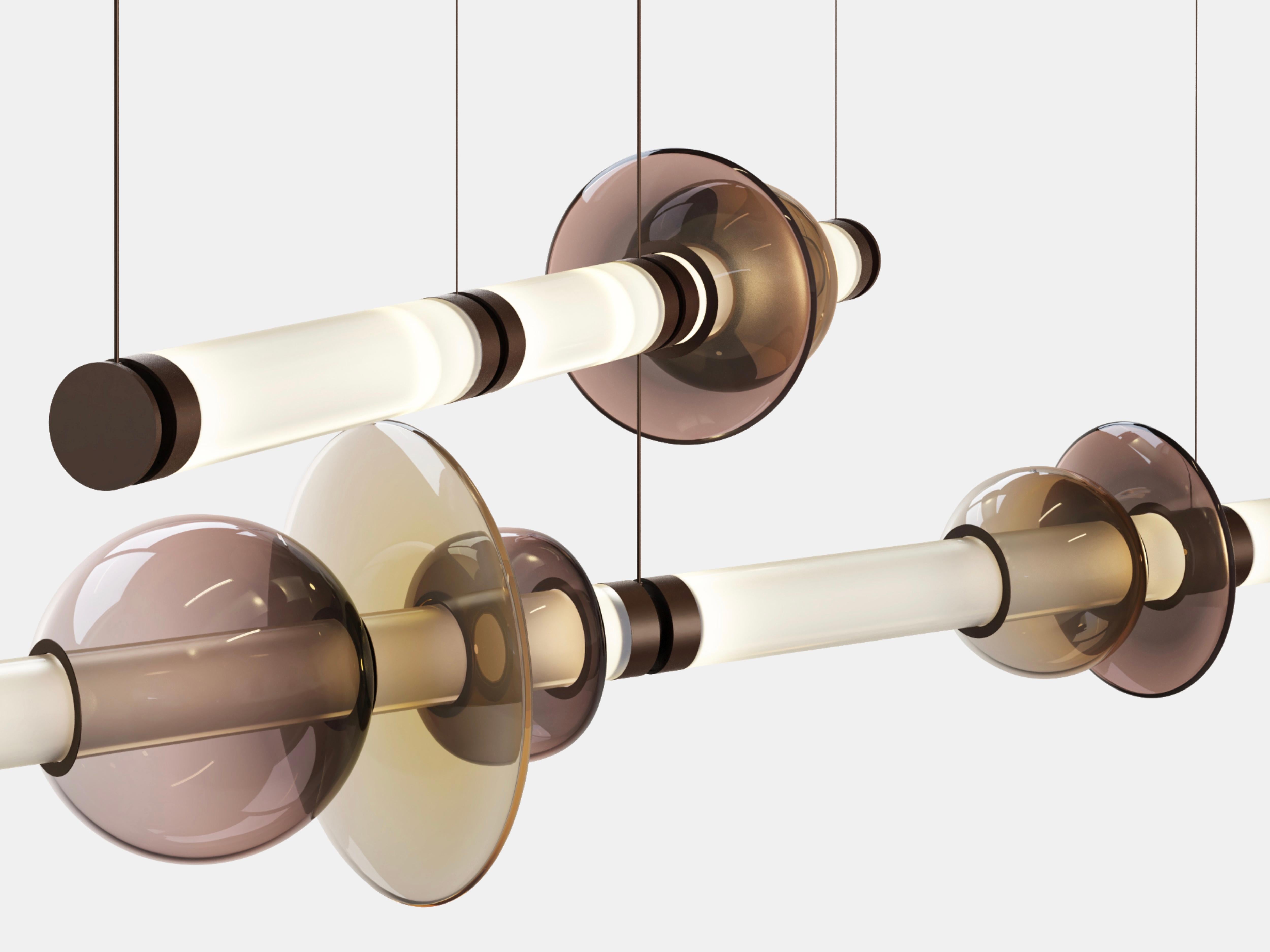 A lighting system with infinite interpretations, the Luna Chandelier 2 Tier  is a synergy of color, shape, and refracted light. Inspired by a lunar halo, the modular light fixture grows in every direction as its assembly system stems horizontally or