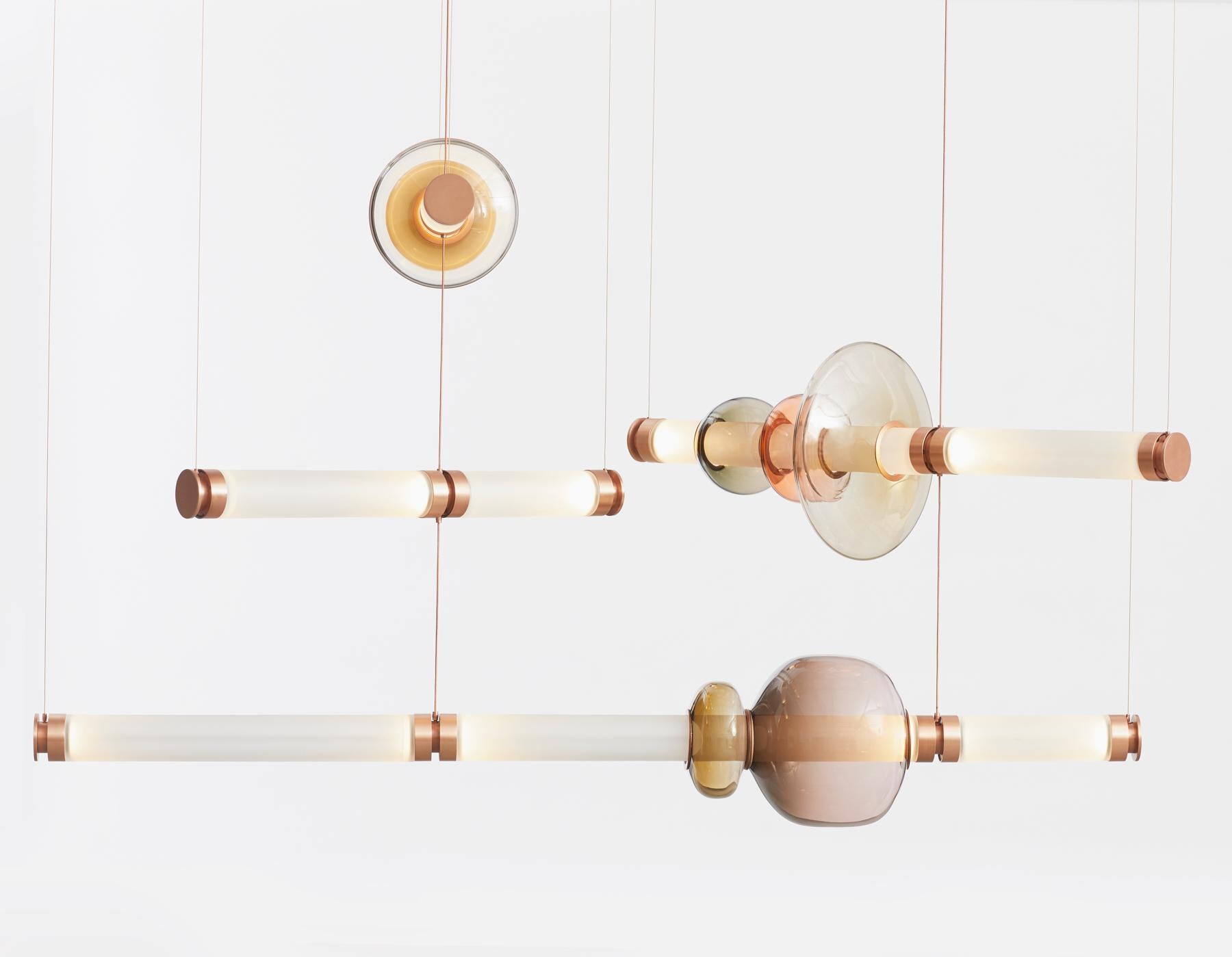 A lighting system with infinite interpretations, the Luna Chandelier 3 Tier  is a synergy of color, shape, and refracted light. Inspired by a lunar halo, the modular light fixture grows in every direction as its assembly system stems horizontally or