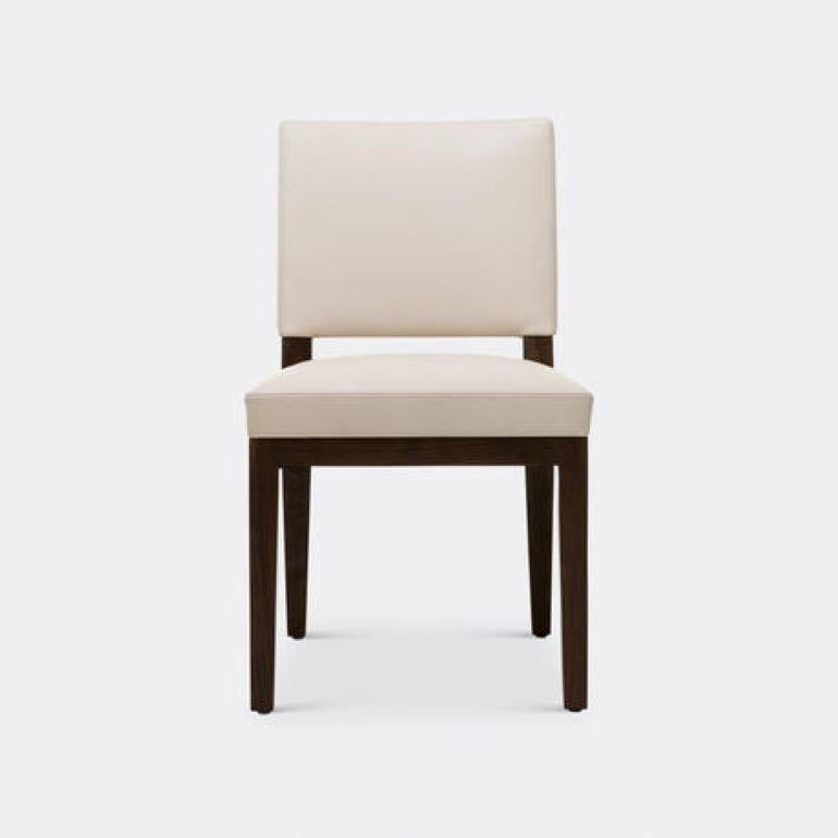 The Luna Dining Side Chair brings elevated style to the table. With its simple and elegant lines, beautiful proportions and seamless upholstery that interlocks with the wood frame, it adds effortless grace and ease to dining areas. It is the