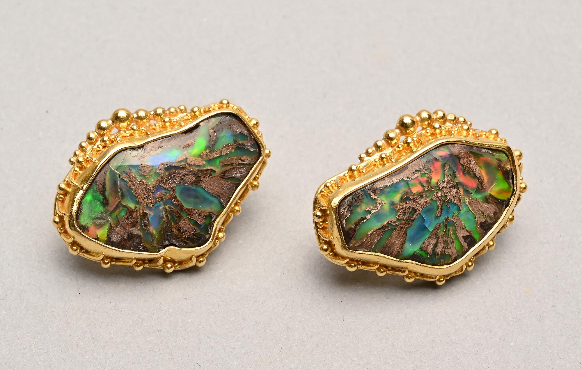 Stunning and unusual earrings by American designer, Luna Felix.  The stones are conk wood which is an opal formed in ancient wood cavities. The only place in the world in which they are found is in the Virgin Valley of Nevada.
The bezels surrounding