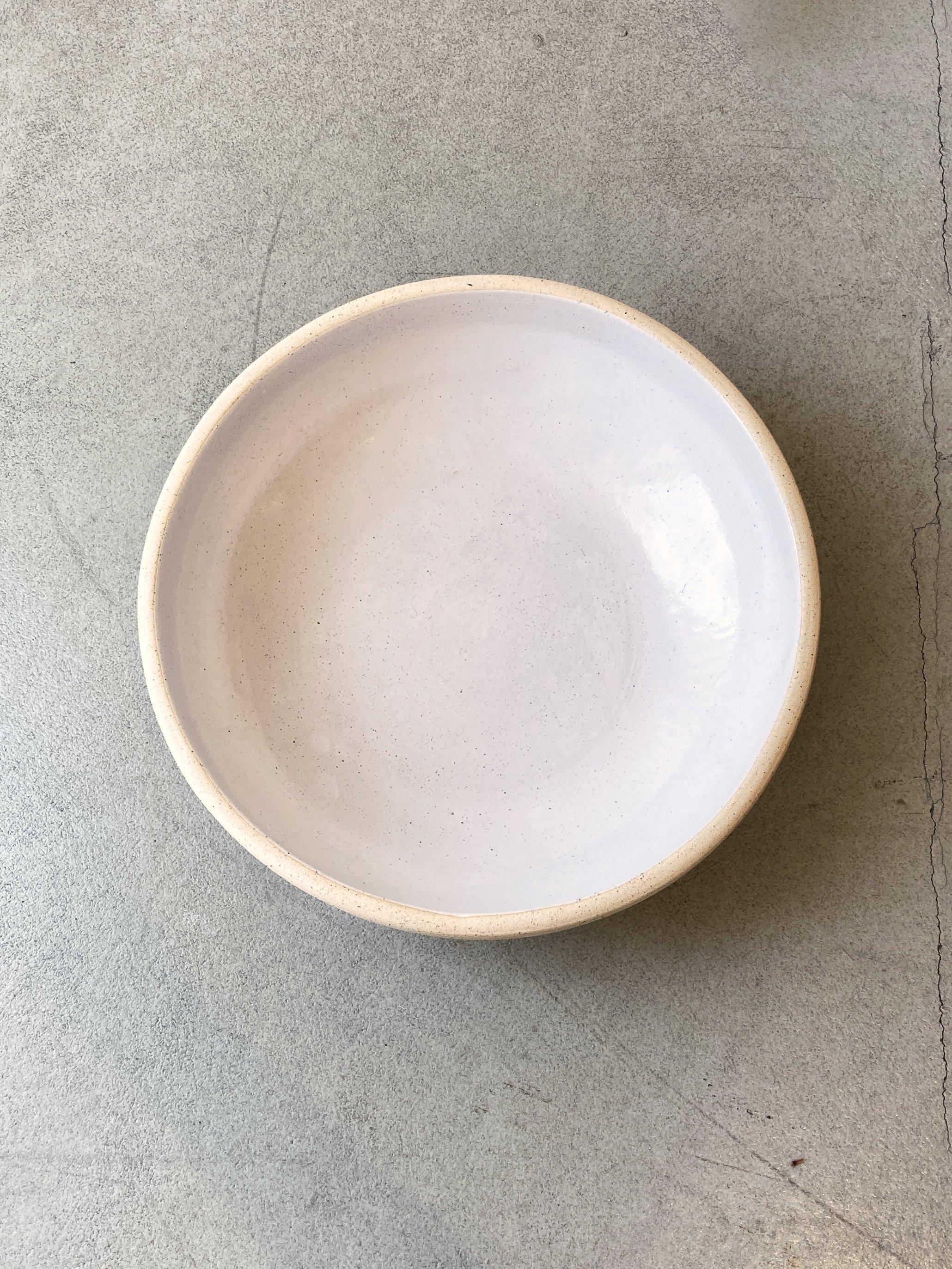A large stoneware bowl with an ivory glaze inside for serving soups, sides, or main courses at your next dinner party. 

Handmade dinnerware from Tlaquepaque, Jalisco, Mexico, by a family of ceramicists that have been creating handmade earthenware