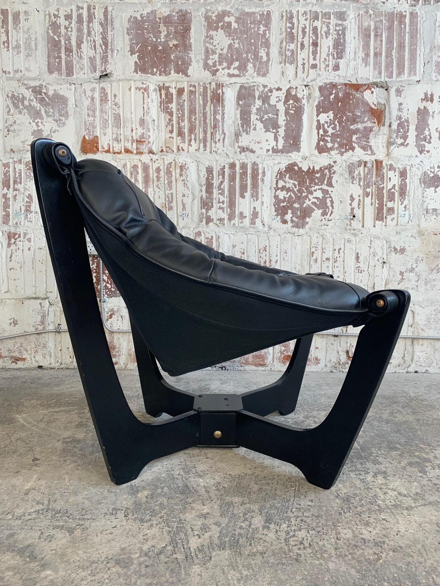 Iconic 'Luna' armchair by Odd Knutsen for Hjellegjerde. Black frame with black leather, circa 1970s. Very good condition.