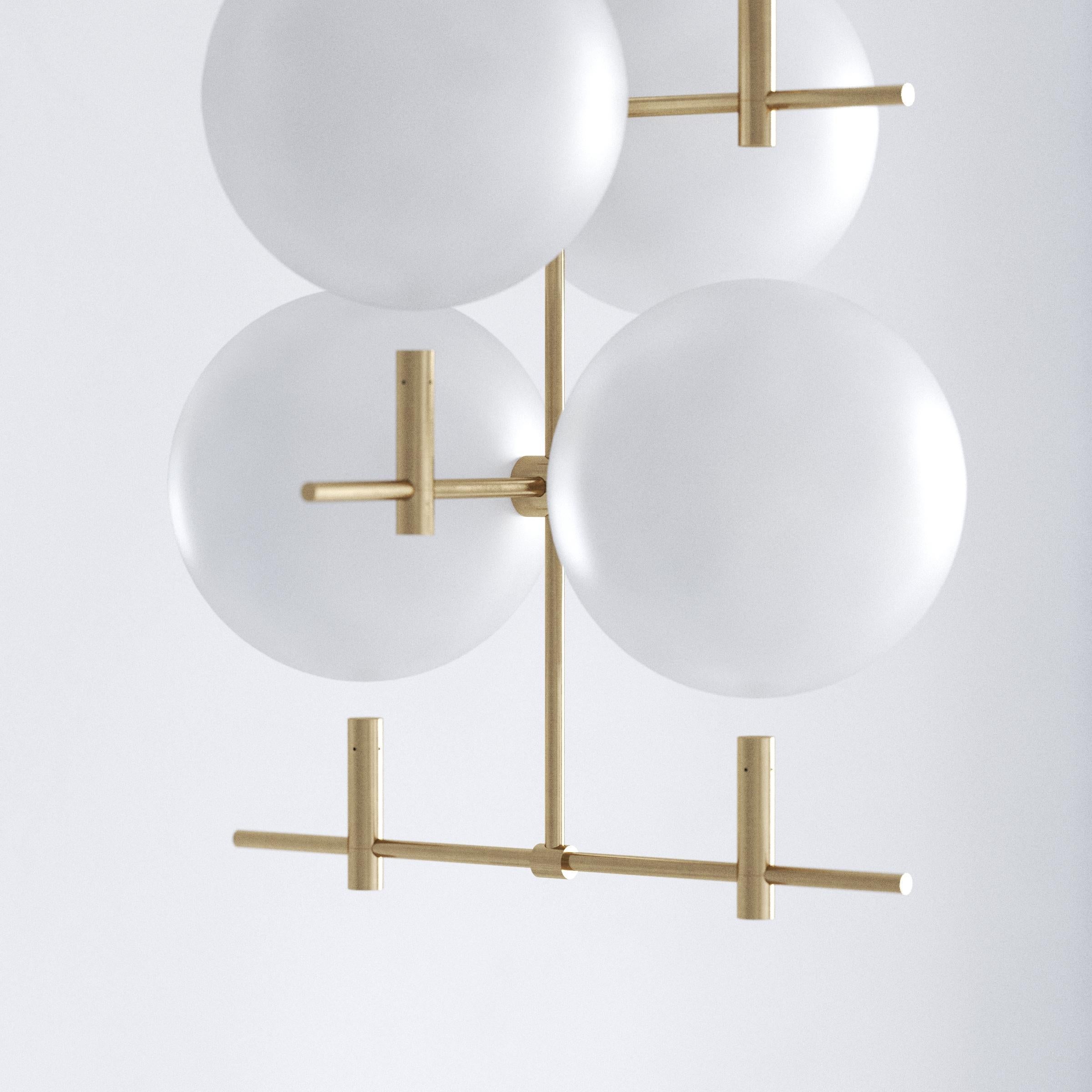 Shifting between day and night, this moody luminaire contrasts monumental hovering glass spheres and subtle metal construction. Luna offers two lighting options. Sun and Moon. Glow and reflection. Soak up the light and let the spheres illuminate the