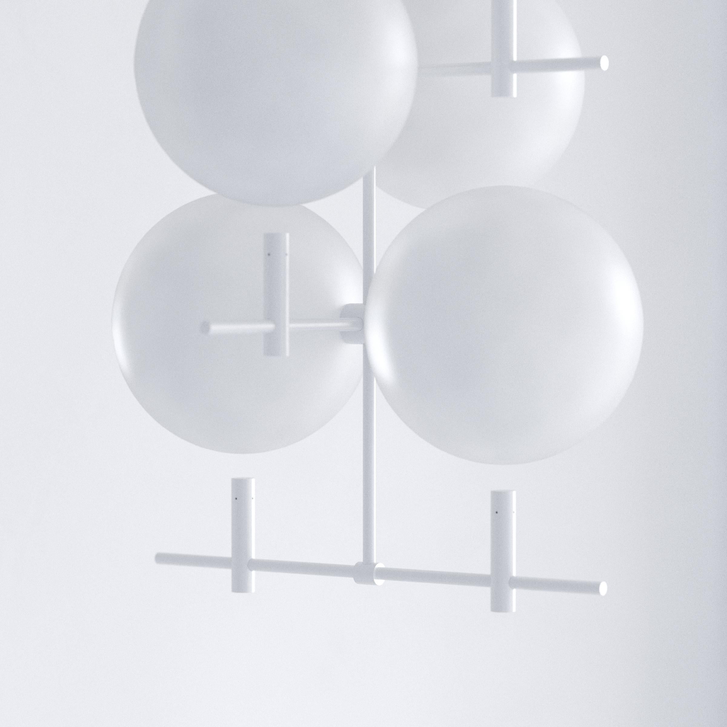 Shifting between day and night, this moody luminaire contrasts monumental hovering glass spheres and subtle metal construction. Luna offers two lighting options. Sun and Moon. Glow and reflection. Soak up the light and let the spheres illuminate the