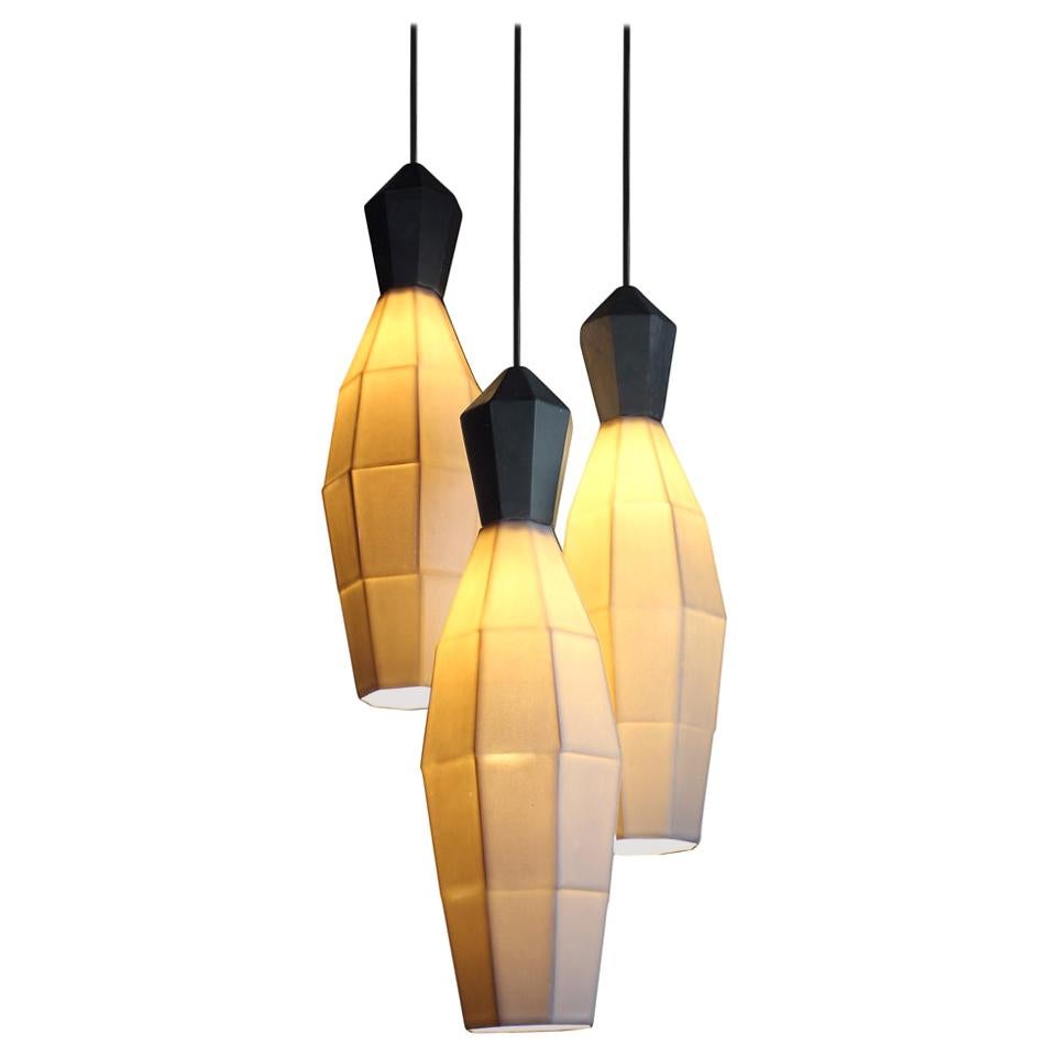Broaden the look of diffused ambient lighting with the medium clustered hanging pendant lamps by The Bright Angle. These geometric, translucent porcelain shades are an updated alternative to the Classic chandelier. From the Extension collection by