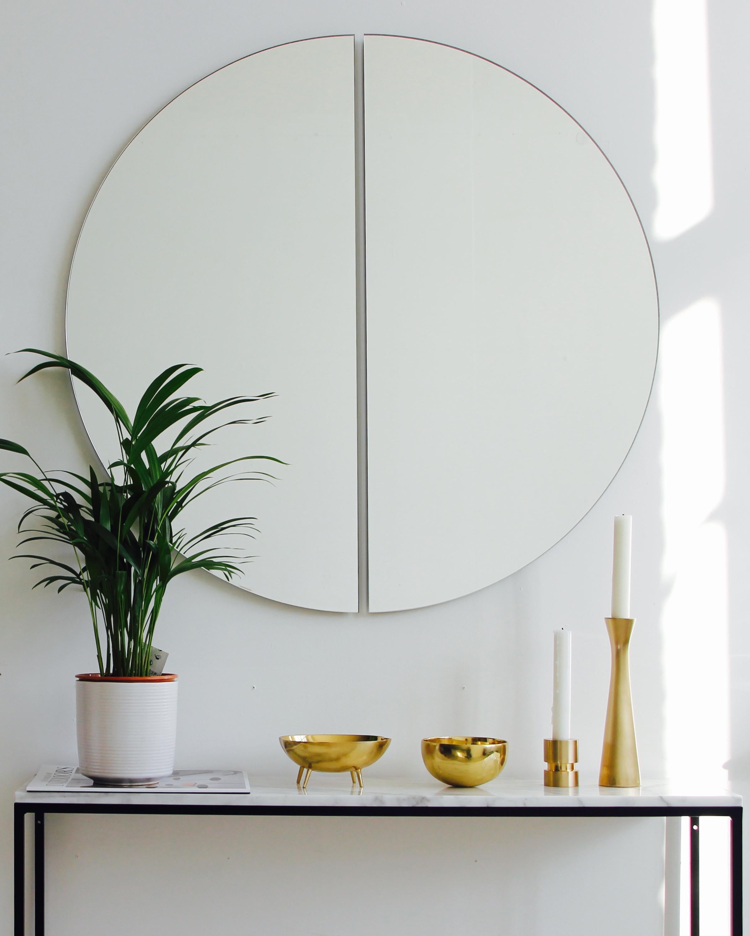 Original and minimalist half-moon frameless mirror with a floating effect. Quality design that ensures the mirror sits perfectly parallel to the wall. Designed and made in London, UK. 

Each piece is fitted with professional plates that allow for an