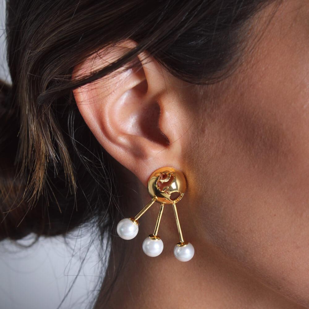 The Luna Pearl Earrings feature a double view design - a gorgeous globe with cut out world map details and a contrasting natural shell pearl that can be seen on the front of the ear.  This pair effortlessly complements any stylish and chic outfit. 