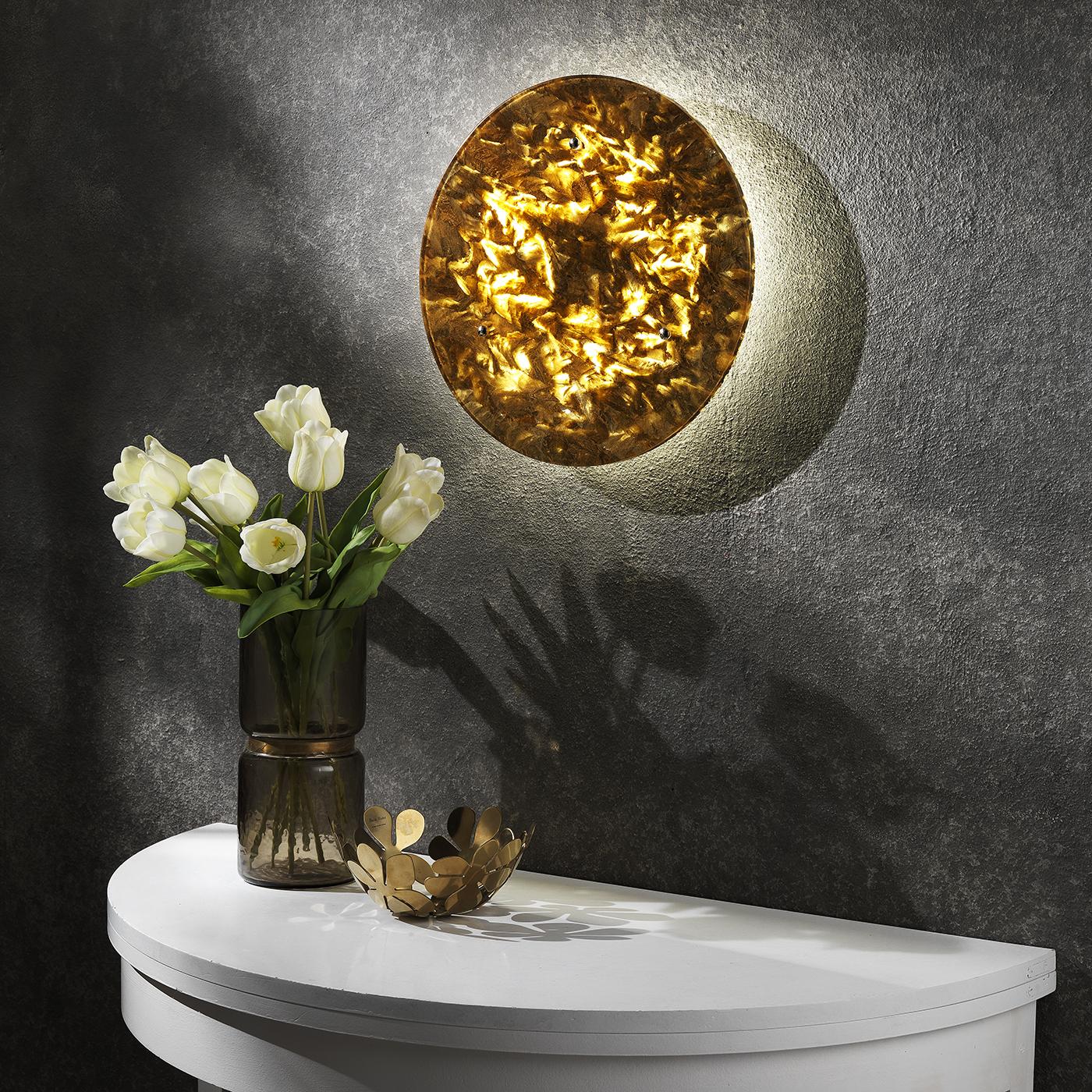 Meticulously handcrafted of Crystal Stone®, a crystalline alabaster unique to a quarry in Italy's Romagna region, this enchanting wall sconce captured the mysterious allure of the moon. The 55cm-diameter surface is sculpted in this translucent