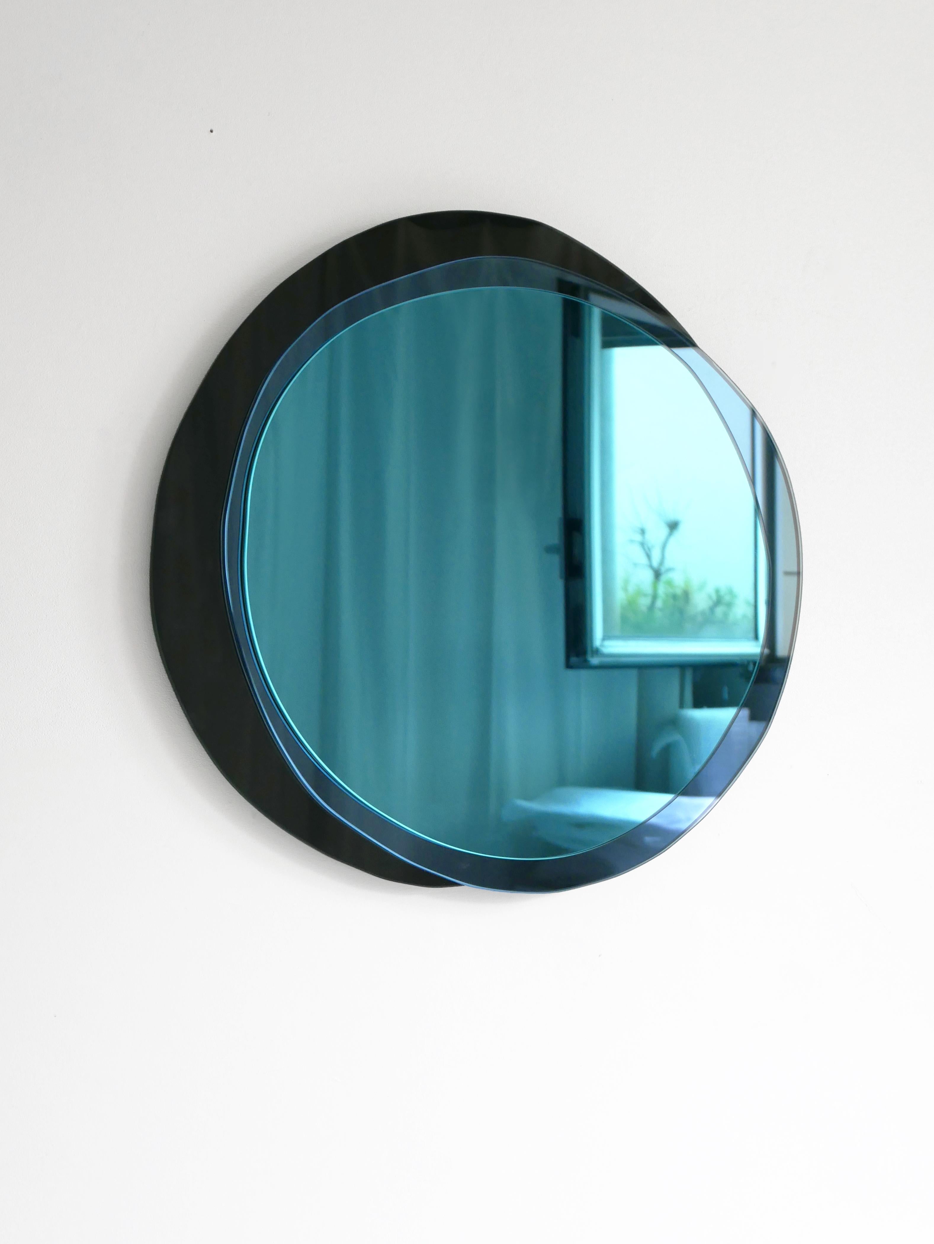 Lunar large hand-sculpted mirror, Laurene Guarneri.
Limited edition.
Handmade.
Materials: Sky blue colored mirror, dark blue colored mirror, dark colored mirror.
Dimensions: 90 x 90 cm

Laurène Guarneri is a designer based in Paris.
Graduated