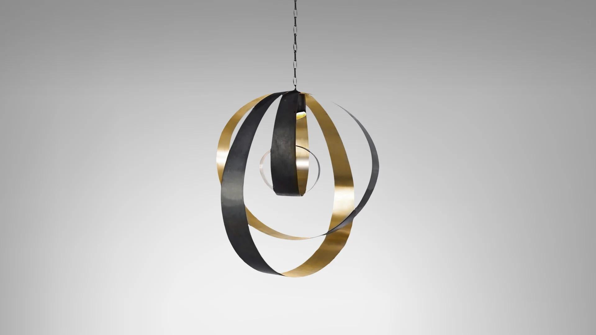 Lunar medium pendant by CTO lighting.
Materials: bronze with satin brass and bronze oval chain with black braided flex.
Dimensions: W 60 x D 40 x H 70 cm

All our lamps can be wired according to each country. If sold to the USA it will be wired