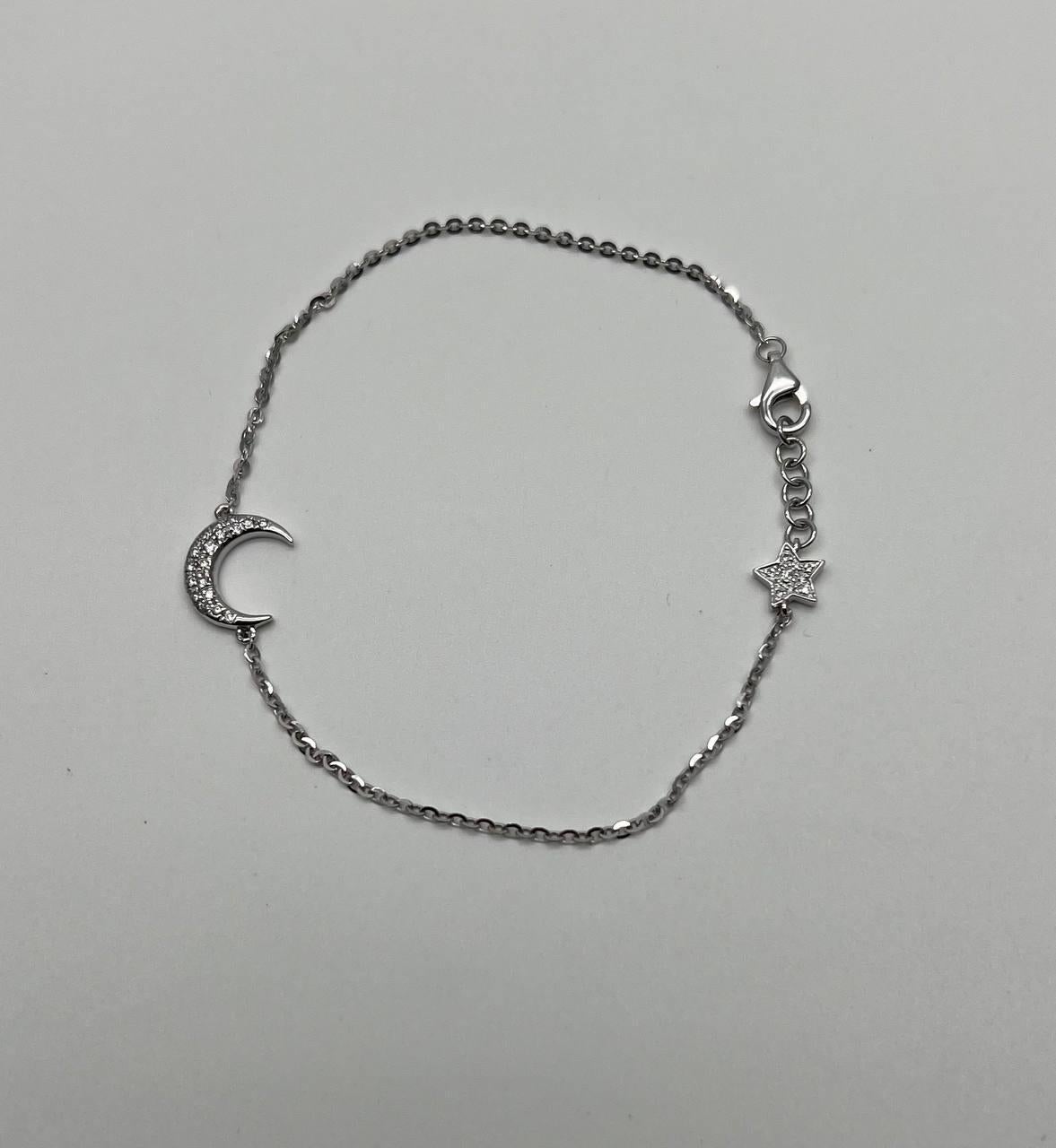 Delicate 18K white gold chain bracelet with crescent moon and star motifs. White diamond accents. Beautiful, dainty, chic, minimalistic, symbolic and perfect to wear by itself or stacked with other bracelets. 0.15 ctw G/VS Diamonds