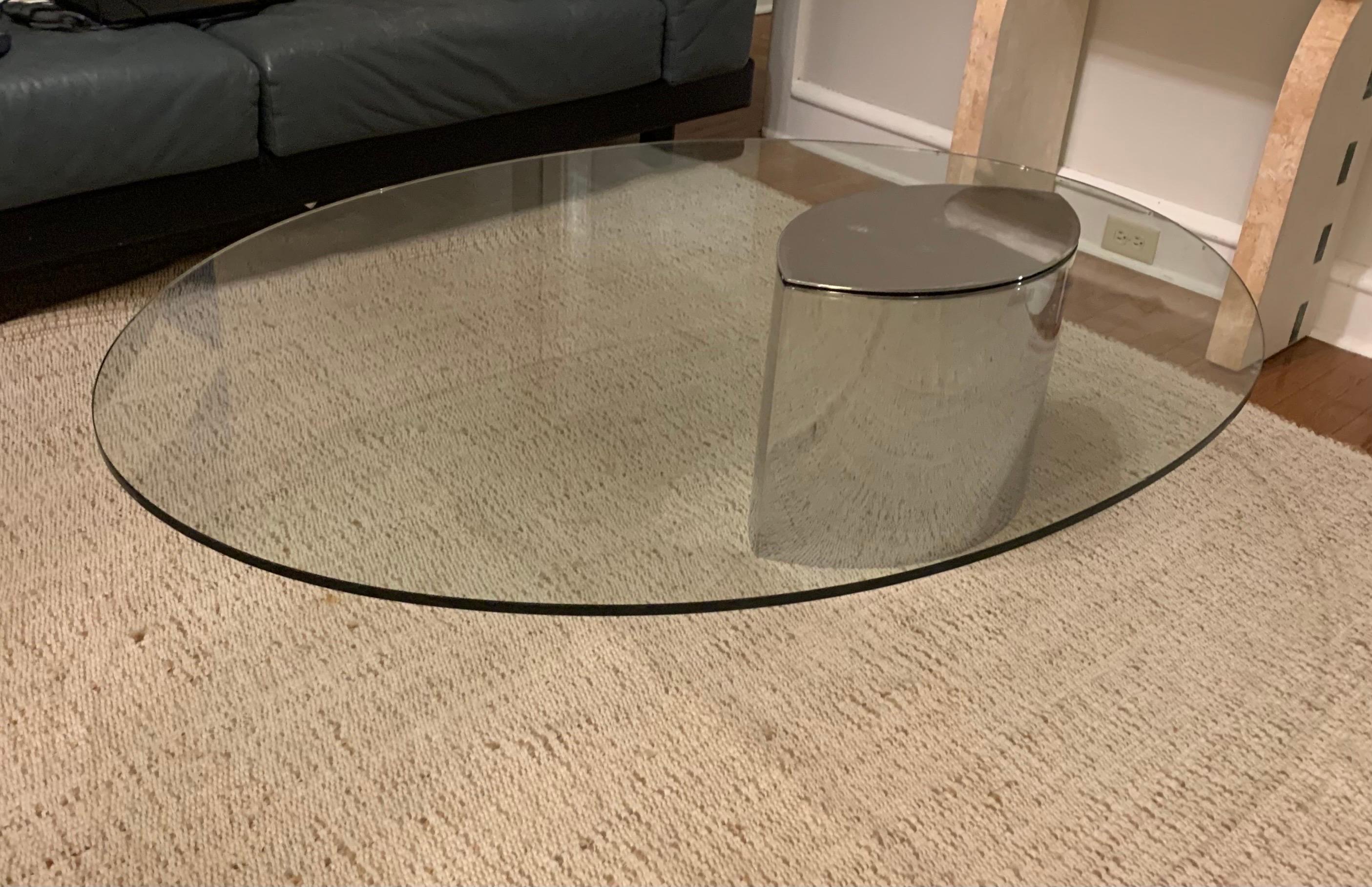 This is an early ‘Lunario’ coffee table, designed in 1968 by Cini Boeri for Gavina.

The piece features a chromed-steel teardrop pedestal base, which is internally weighted to counterbalance its off-center oval glass tabletop.

The table retains its