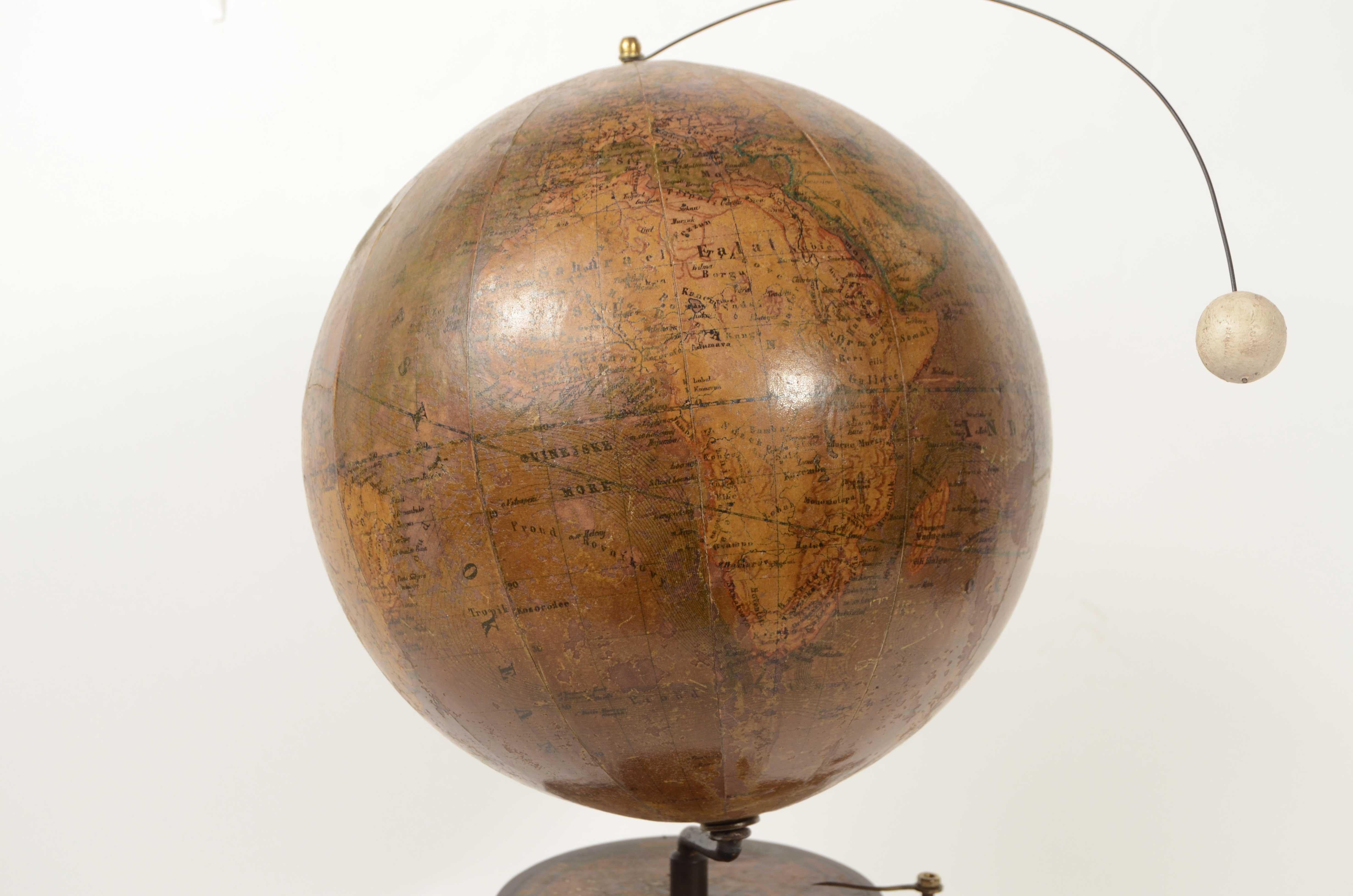 Handcrafted mechanical lunarium with cast iron base, second half of the 19th century, surmounted by  a globe made by cartographer Jan Felkl. Turning the crank placed under the circle of zodiac signs by means of the  gears, you can see the Earth and
