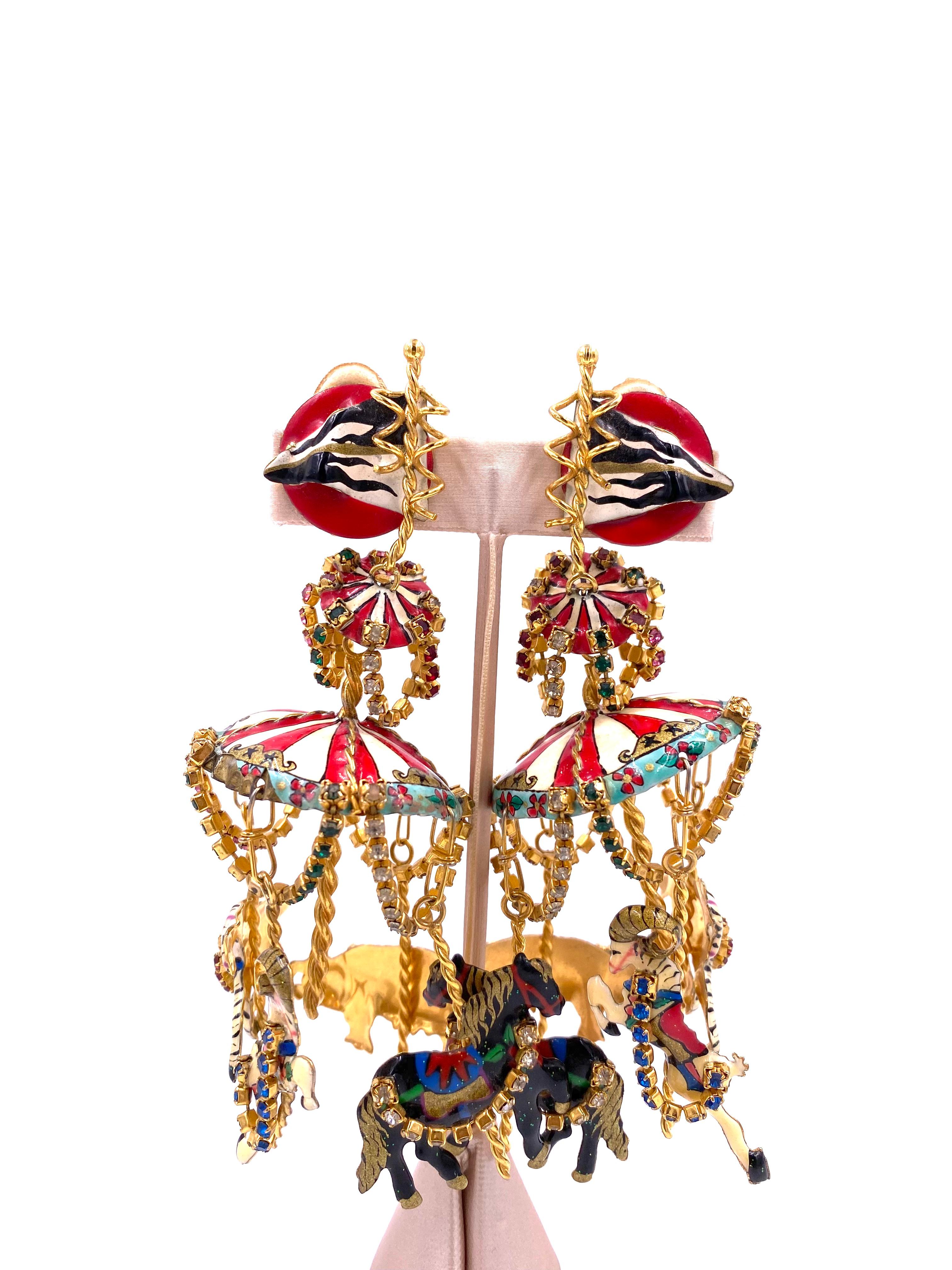 Adorn yourself with the whimsical and playful Lunch at the Ritz Carousel Earrings. Featuring colorful rhinestone chains and a striped carousel top adorned with ponies, rams, rhinos, and zebras, these earrings are a collectible must-have. Make a