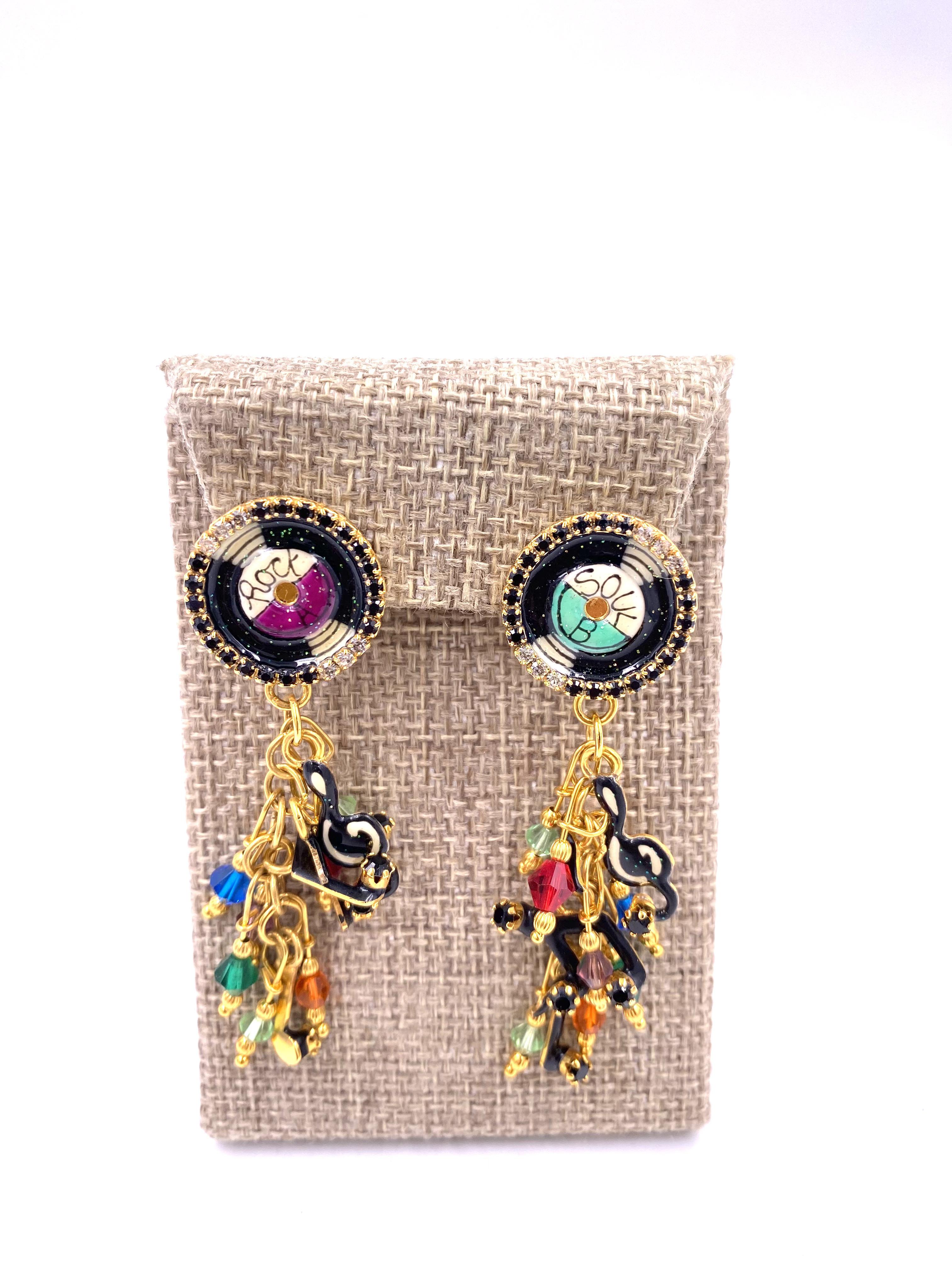 Indulge in elegance with Lunch at the Ritz Earrings, featuring a harmonious blend of vibrant multicolor beads, black and clear rhinestones, and gold trim. The circular vinyl detail adds a touch of musical rhythm to these luxurious earrings. Elevate