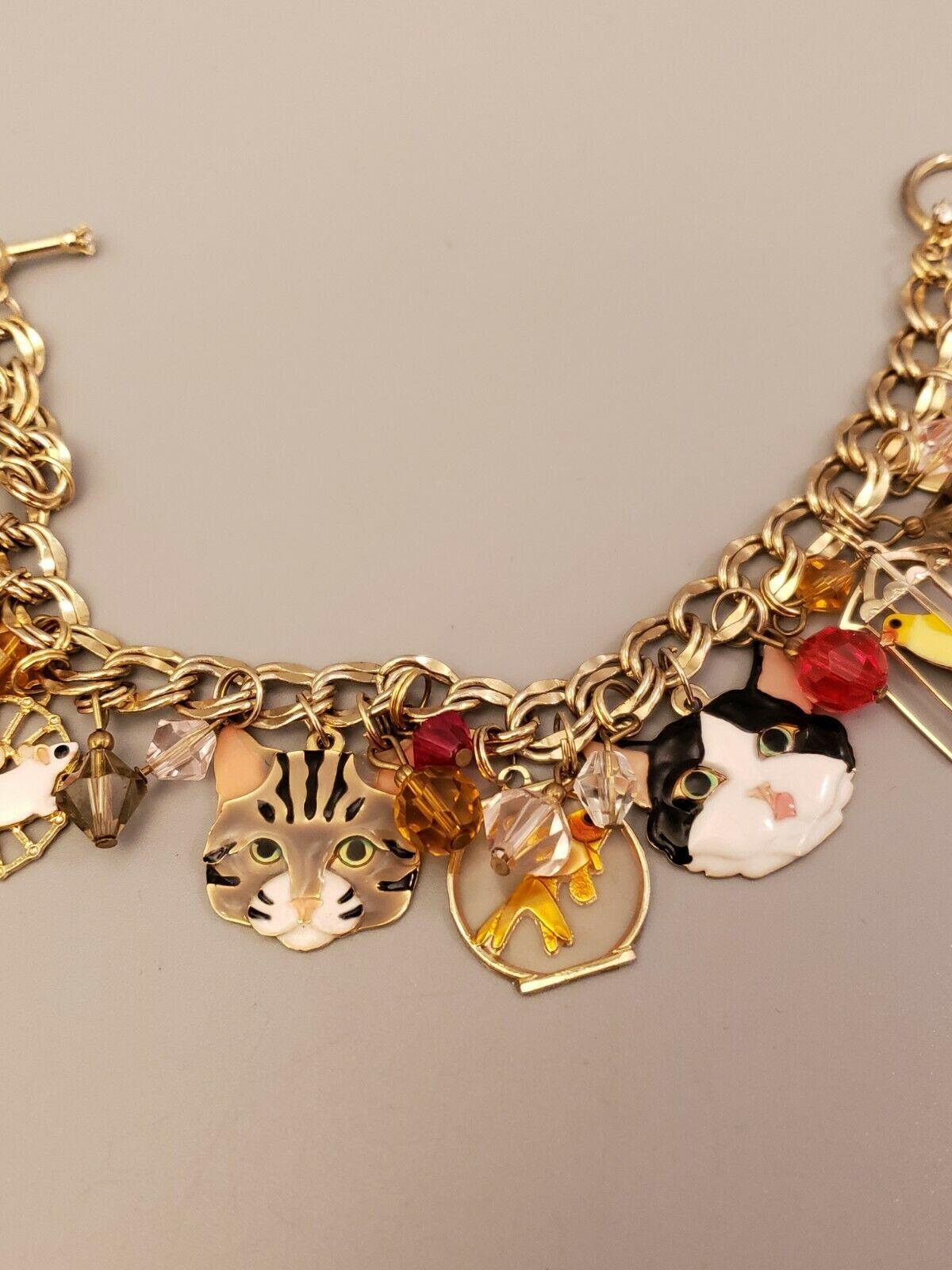 Simply Delightful! Vintage Signed Lunch at the Ritz Multi Charm Cat, Mouse and Bird in a Cage Bracelet. Enamel, Gold Tone. Measuring approx. 7.5” Long. Excellent Condition. Chic and Fun to Wear! Sure to be admired...A piece you'll turn to time and