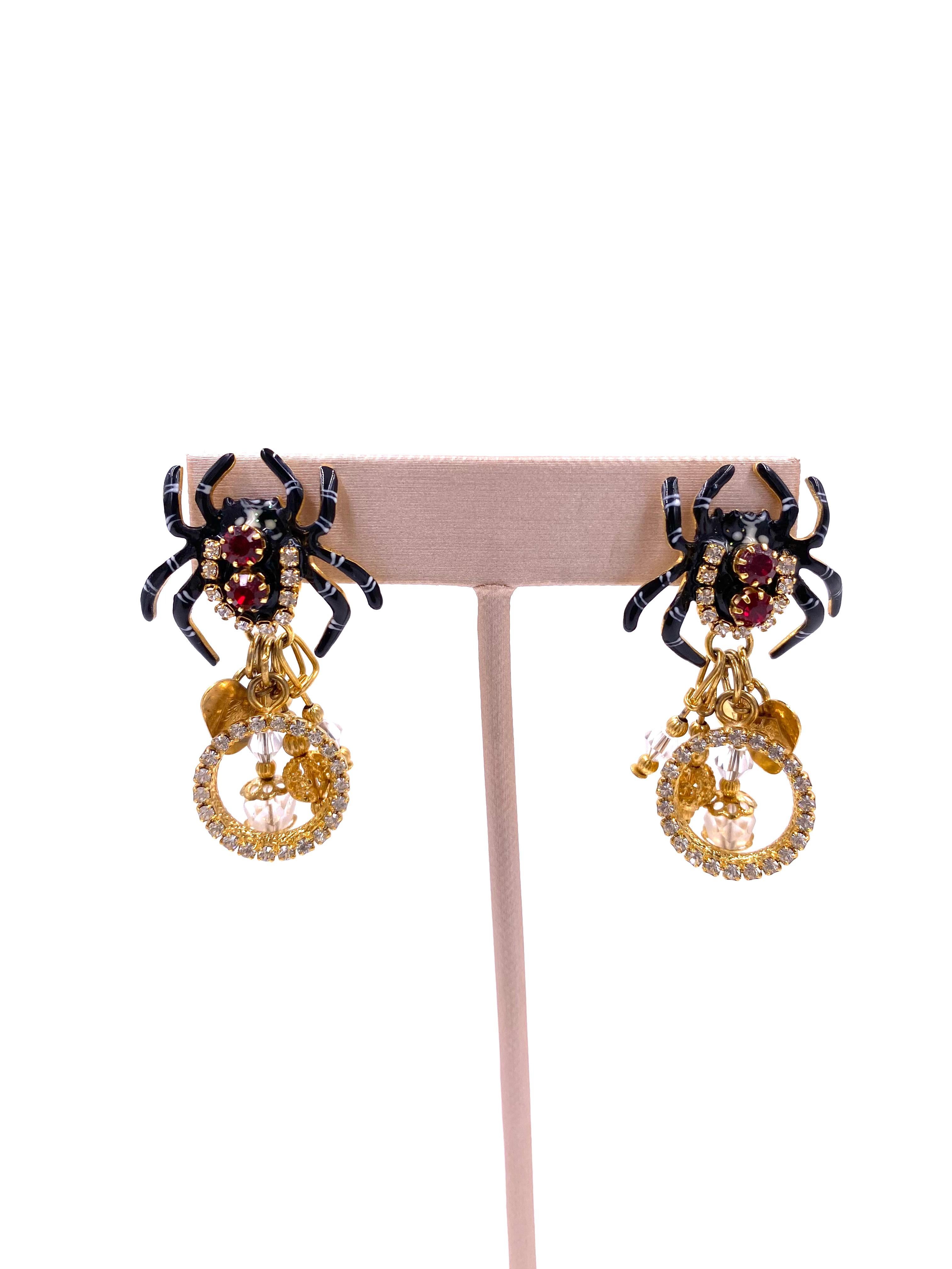 Indulge in luxury with Lunch at the Ritz Spider Spumoni earrings. The black spider design, adorned with gold and red rhinestone details, exudes sophistication and exclusivity. Elevate your style and make a statement with these elegant