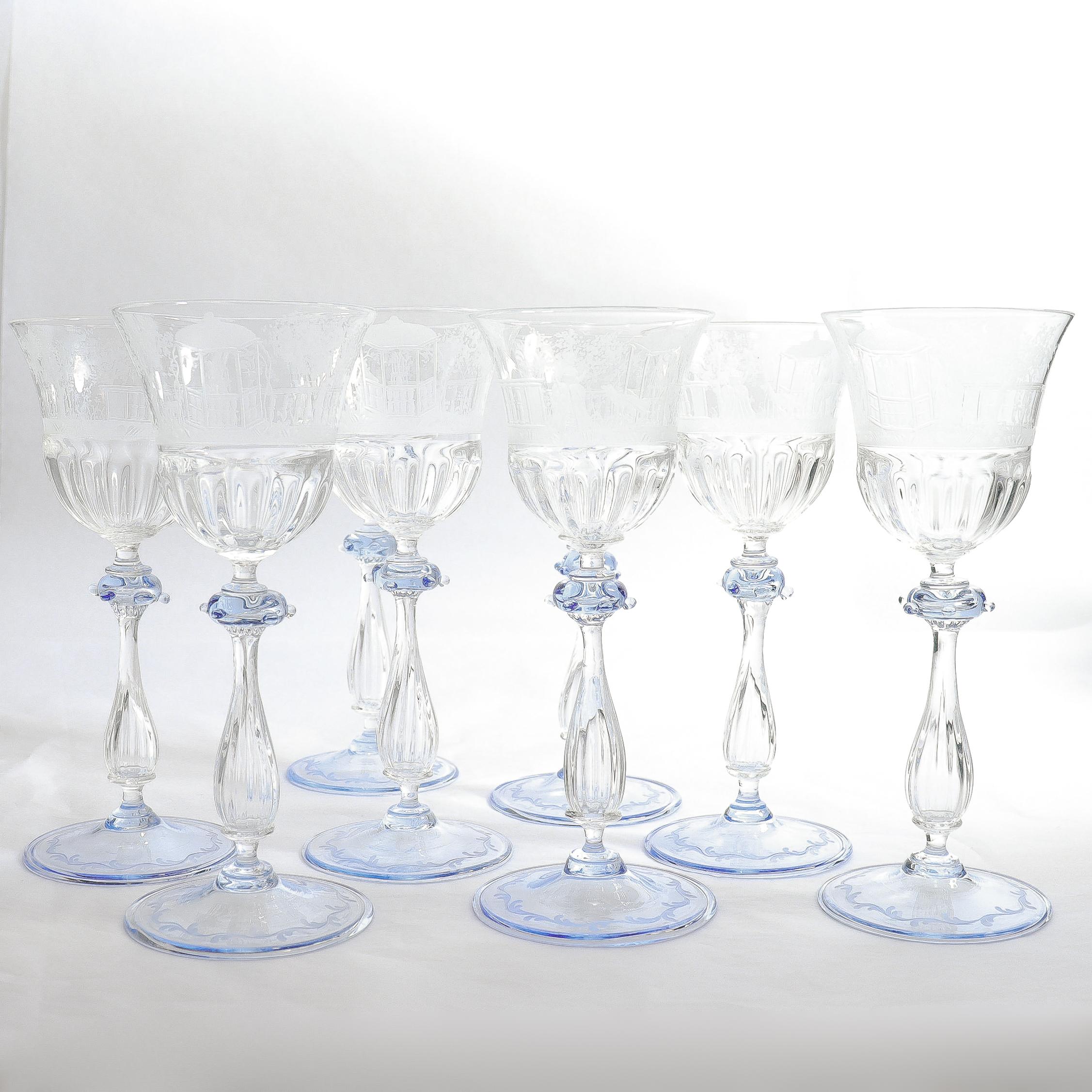 A fine vintage set of 8 Venetian glass wine stems or goblets.

Attributed to Salviati.

In clear glass with a light blue suppressed ball knops with small applied prunts, fluted baluser stems, and blue wafer feet. 

Each shaped cup engraved with