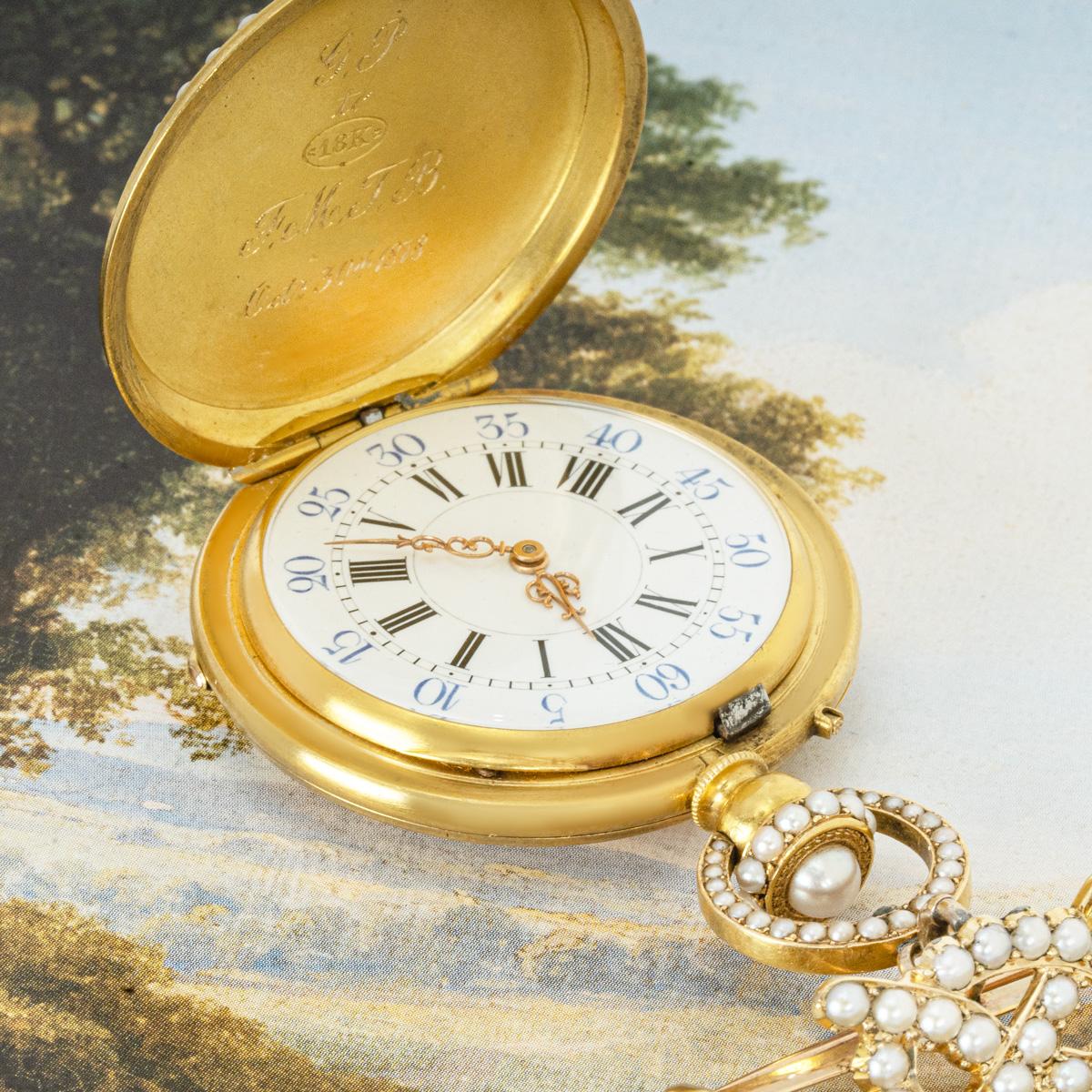 Lund & Blockley. A Gold Enamel and Pearl Full Hunter Keyless Cylinder Fob Watch With Matching Pearl and Diamond Brooch. C1880

Dial: A beautiful white enamel dial with black Roman Numerals and outer minute track with very unusual blue Arabic numbers