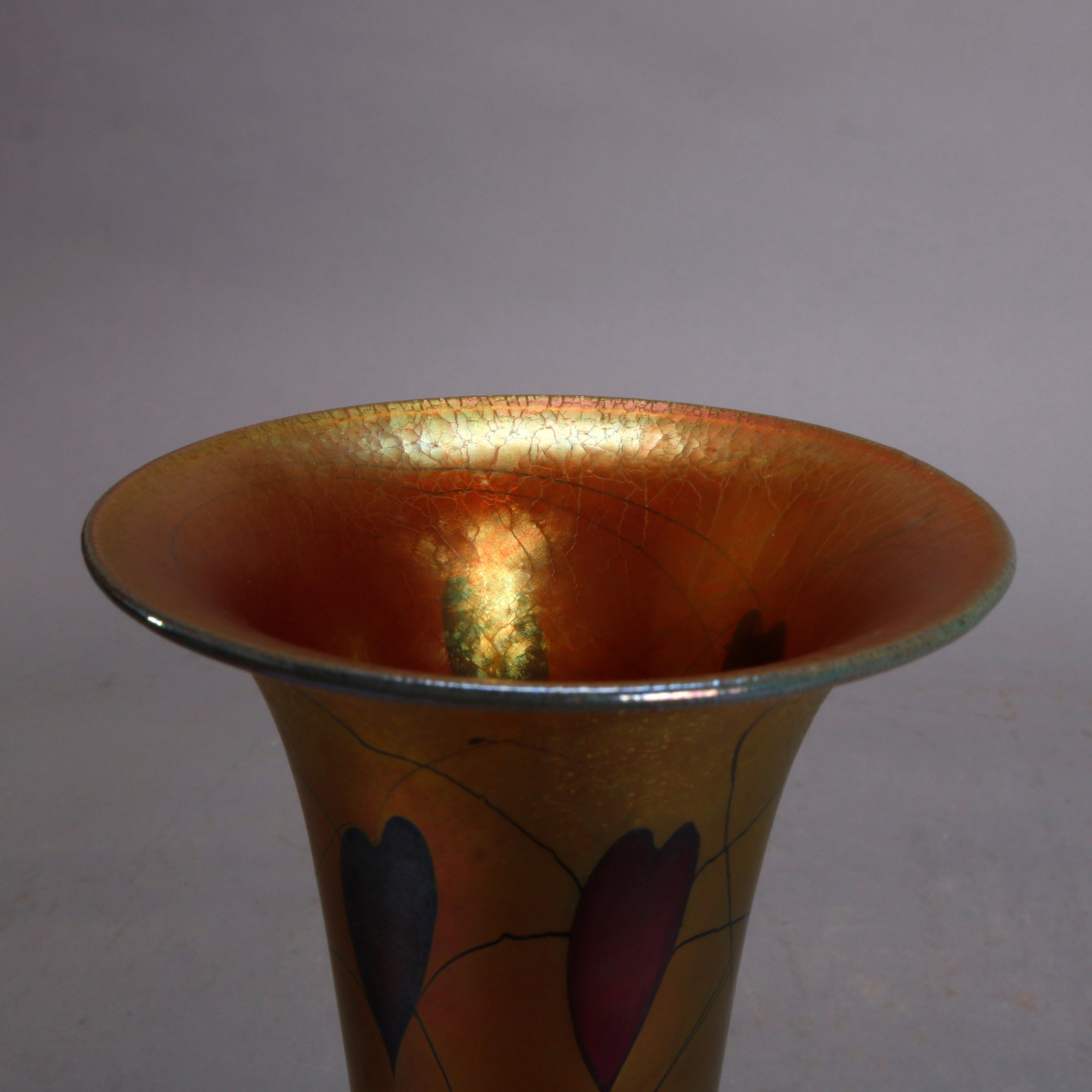 A Arts & Crafts style art glass vase by Lundberg Studios offers trumpet form with gold aurene finish and having heart and vise design, signed on base as photographed, 20th century

Measures: 10