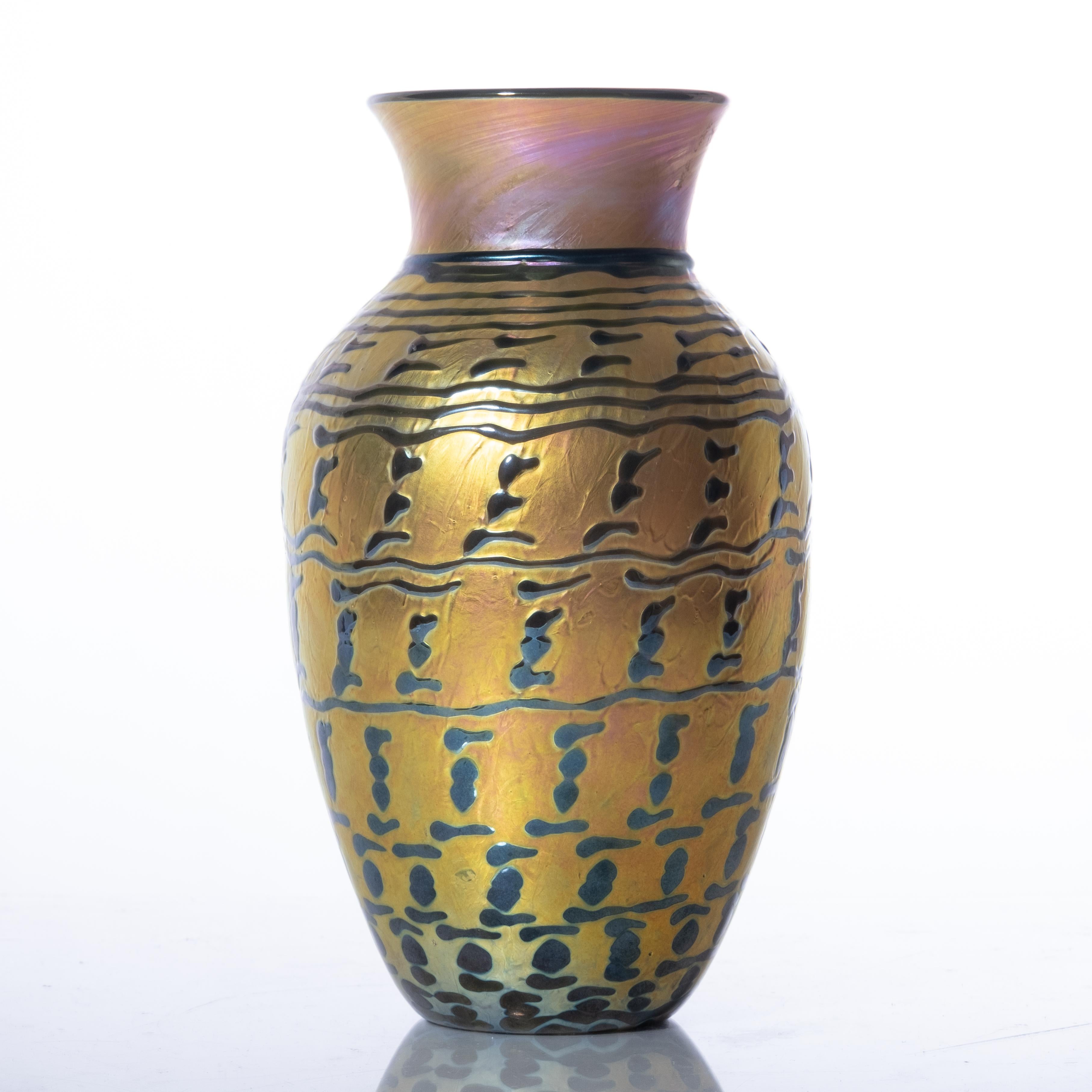 Lundburg Studios (American, established in 1970 by James Lundberg). Jade Indian Basket Gourd Vase. An iridescent vase having enamel relief decoration. Lot is accompanied by card, noting design # & name, circa 1997.

Provenance is the Cordts