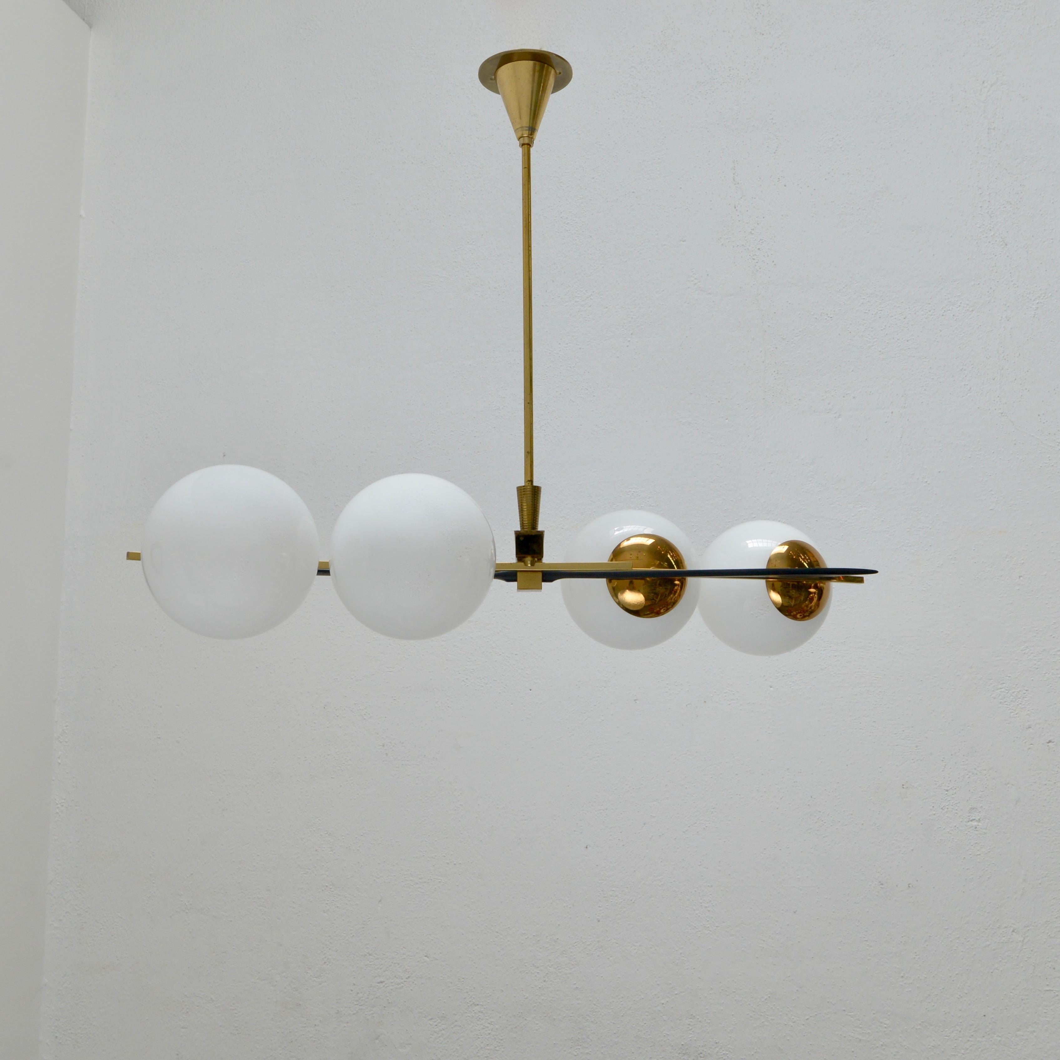 Beautiful 4 globe classical midcentury 1950s French glass, aluminum and naturally aged large brass chandelier by Lunel. With 4-E12 candelabrum based sockets (1) per shade. Wired for use in the US. Light bulbs included with order.
Measurements:
OAD