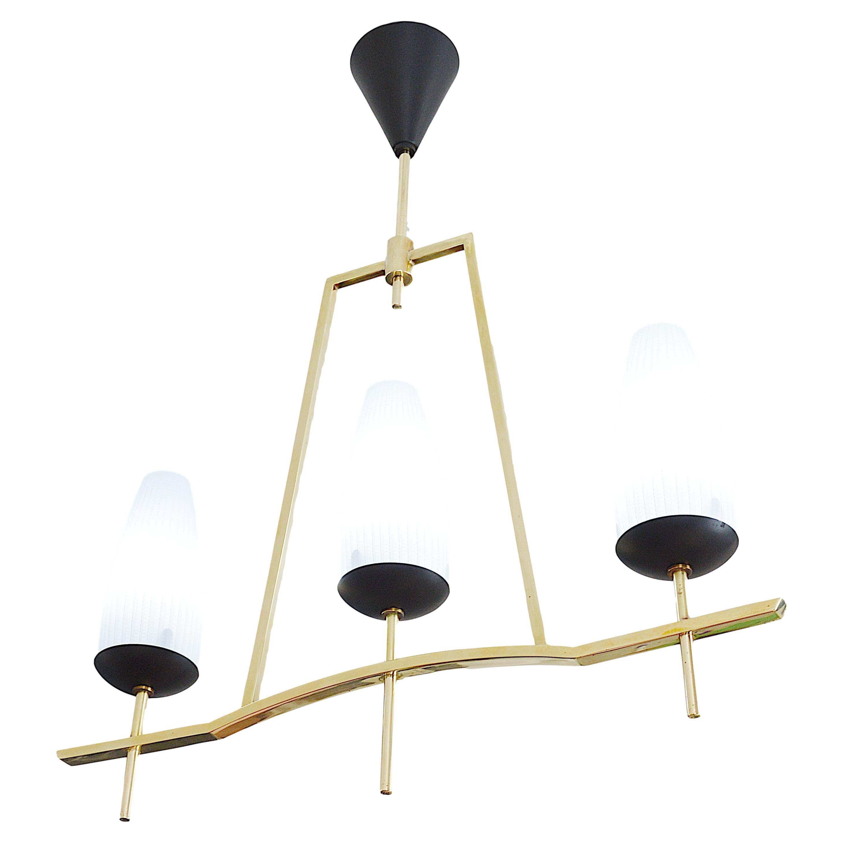 French mid-century chandelier by Lunel (Paris), France, 1950s. Brass, metal and glass. Measures: height 24.2