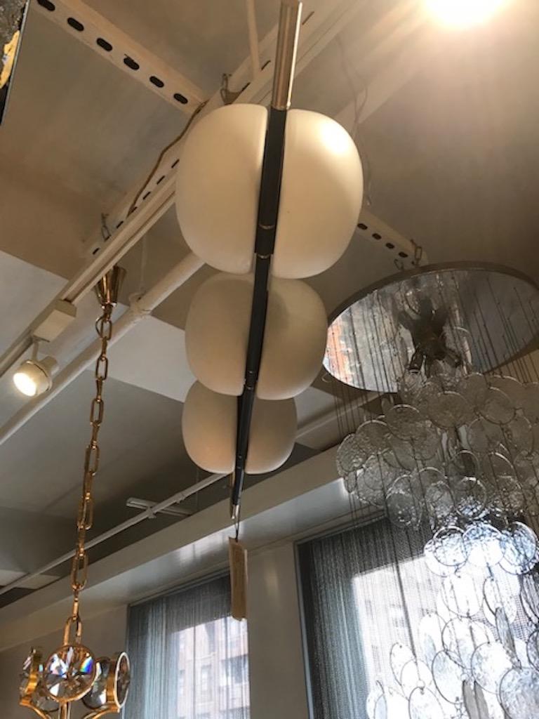 French Mid-Century chandelier composed of a matte black enamel arm with satin brass details which holds six white satin glass globes. Rewired for use in the USA. Can also mount to wall as a large sconce.