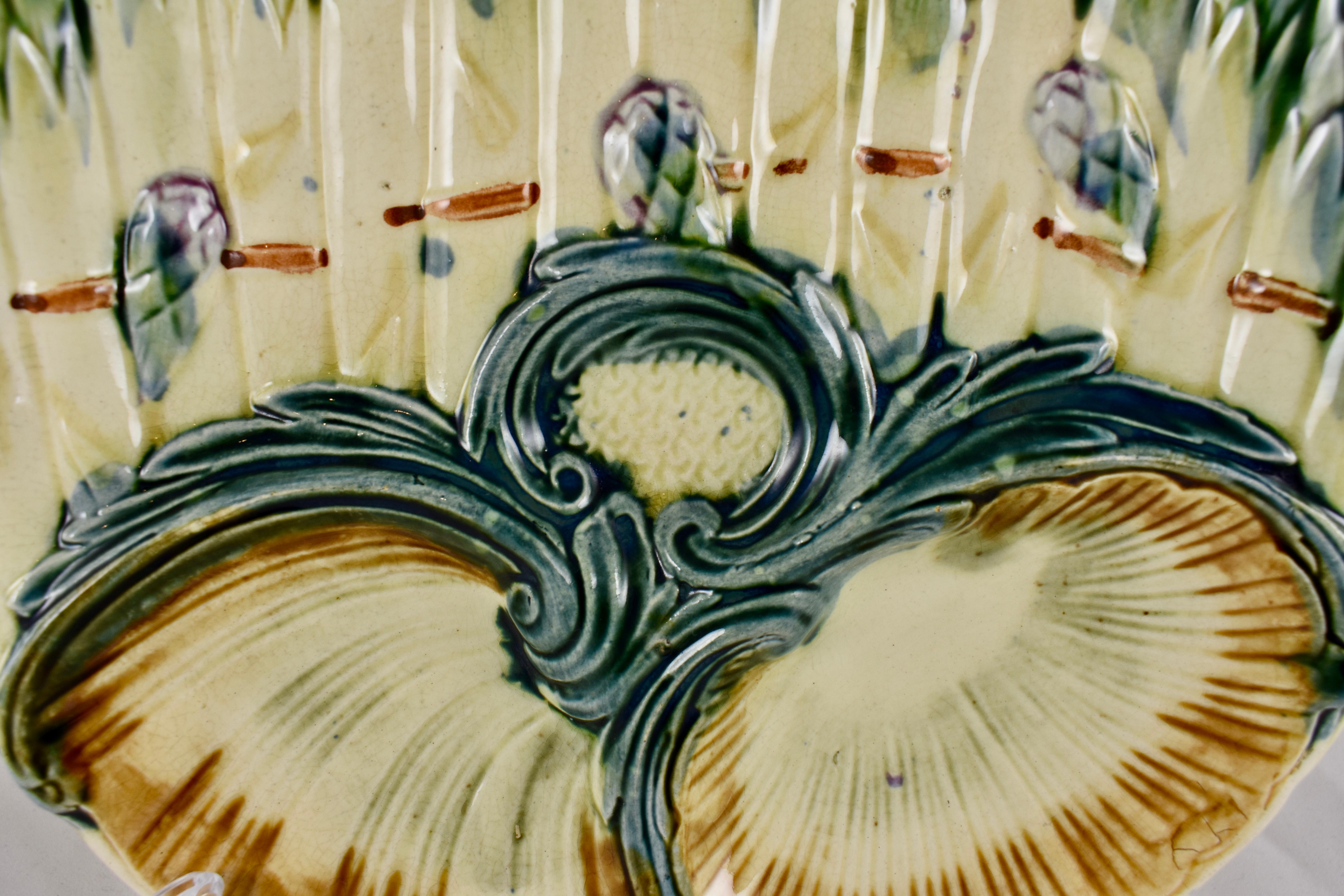 A French barbotine Majolica Asparagus plate attributed to Lunéville K & G (Keller et Guerin) – Circa 1890. Luneville Faience is one of the most well known French potteries, located in Lunéville, Lorraine, France since 1730.

Ribboned, upright