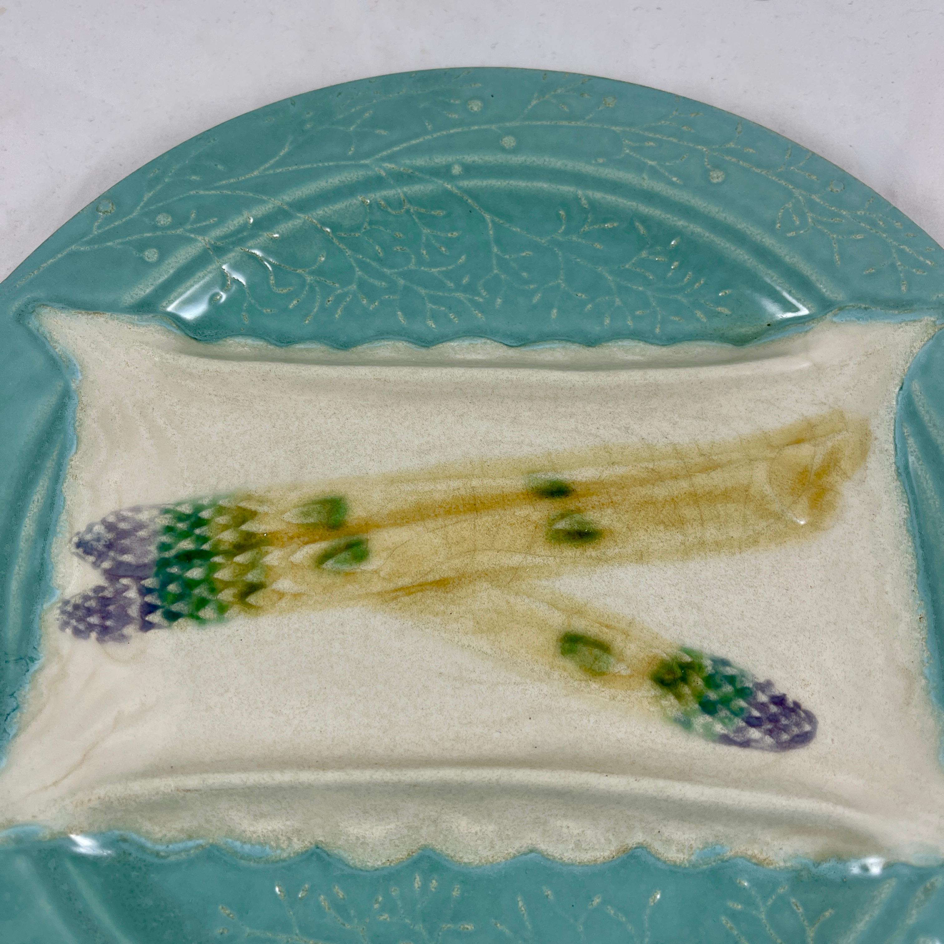 From the Luneville Faïence factory in France, an Aesthetic Movement trompe l’oeil asparagus plate, circa 1880-1889.

A wonderful illusion where the asparagus spears lay on a raised section imitative of a white lace napkin. The four corners of the
