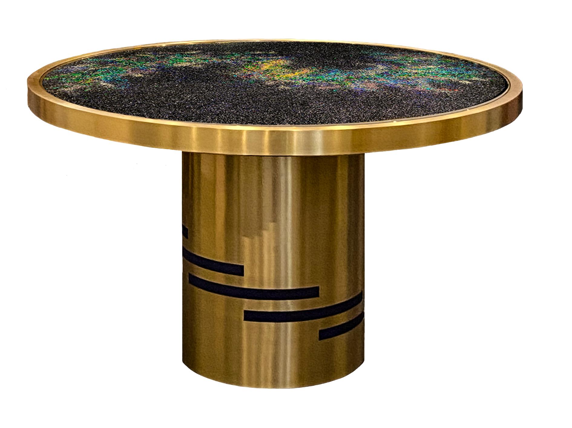 L’UNIVERSO” is a one-of-a-kind table, designed and manufactured by KalaRara. The tabletop is completely made of crushed Murano glass and acrylic. An inset extra-clear tempered glass panel covers the tabletop inset in a brushed finished brass frame
