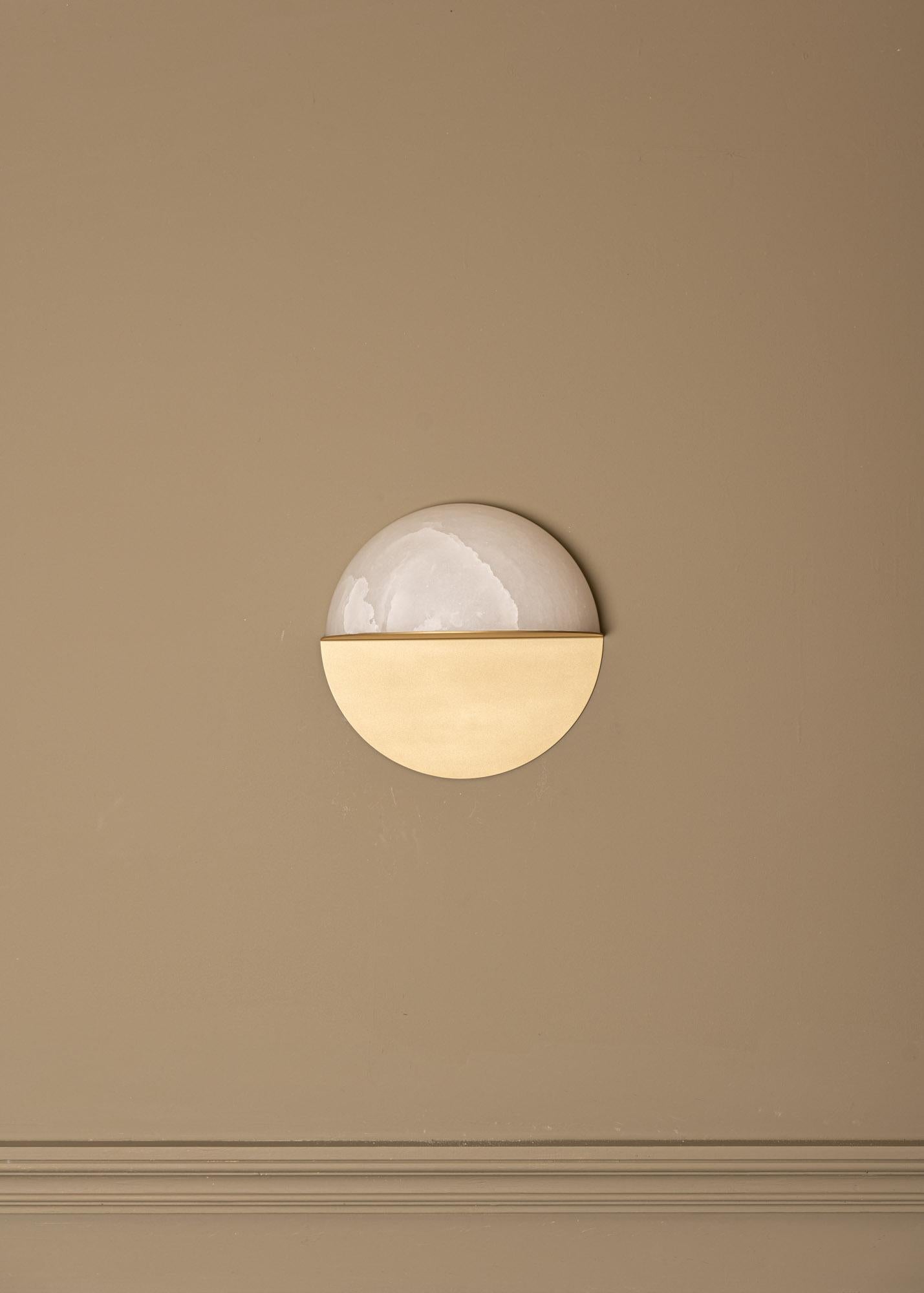 Luno Brass Wall Sconce by Simone & Marcel
Dimensions: D 13 x W 27 x H 27 cm.
Materials: Brass and alabaster.

Available in different brass and alabaster options and finishes. Custom options available on request. Please contact us. 

All our lamps