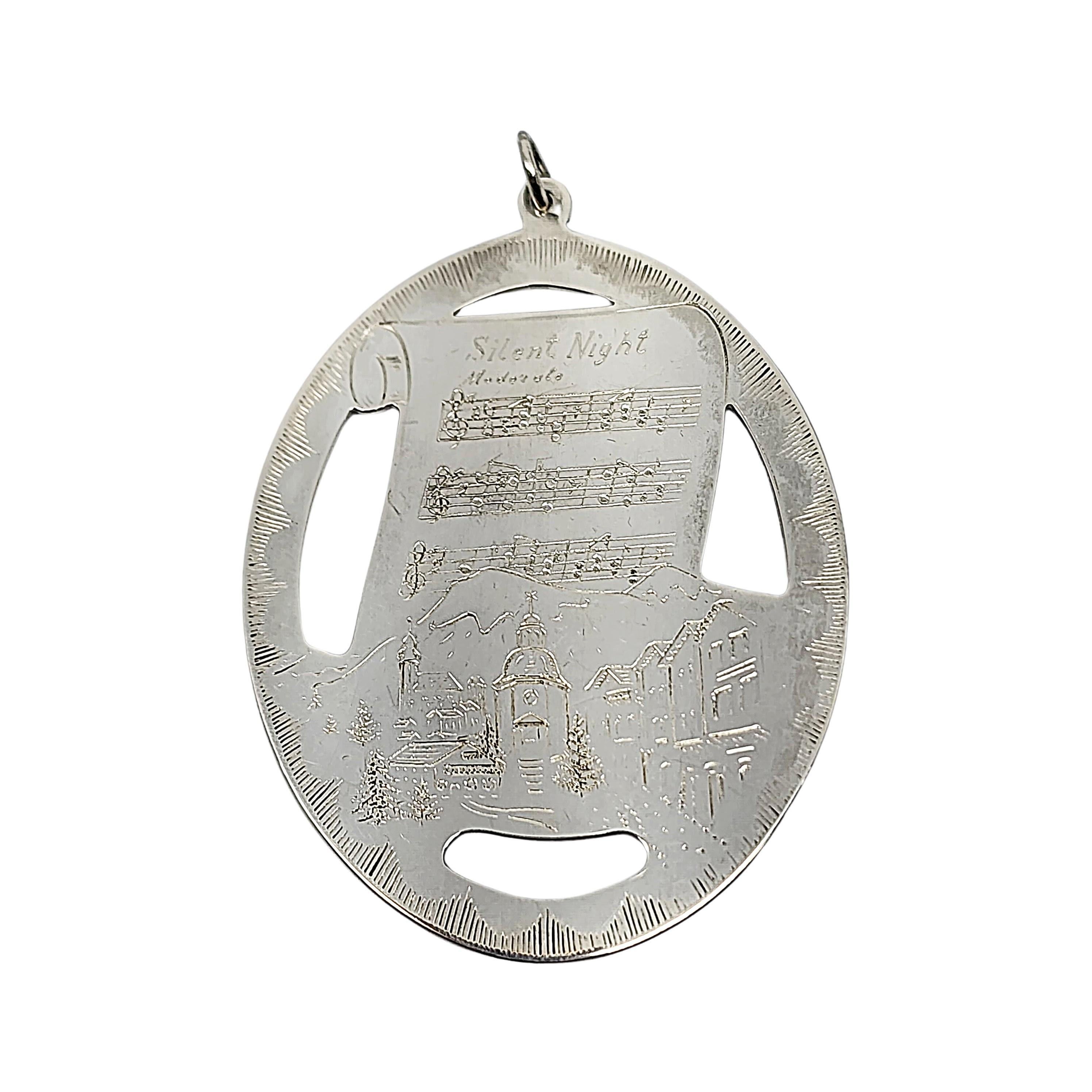 Lunt sterling silver Silent Night medallion ornament from 1977, with box and pouch.

This Silent Night ornament was second in Lunt's collection of Sterling Silver Christmas Medallions featuring The Music of Christmas. One side is etched with Silent