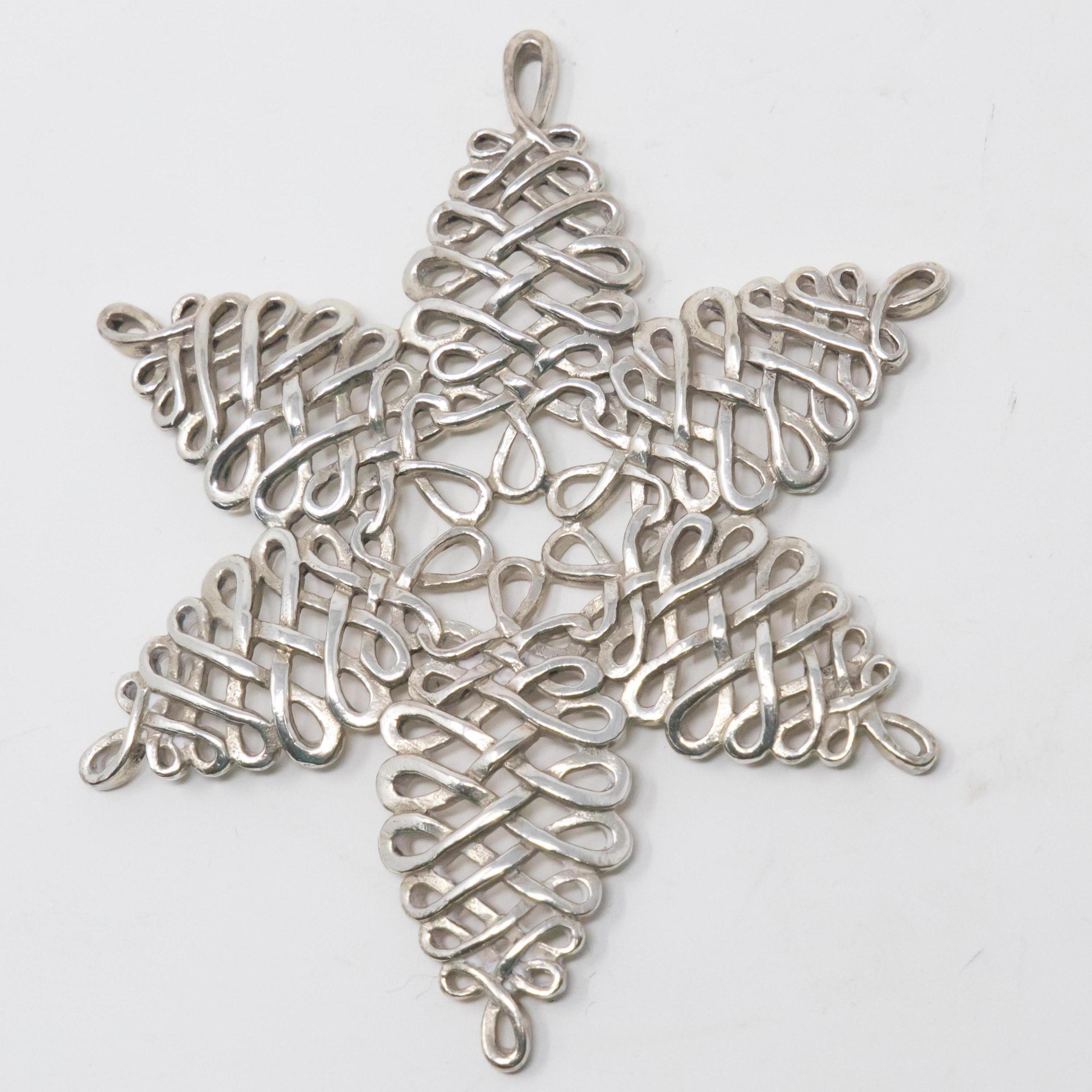 Offering this stunning openwork snowflake from 2000. Beautiful geometric loops and braids make this an eyecatcher. Marked on the back with, 2000, Lunt Sterling.