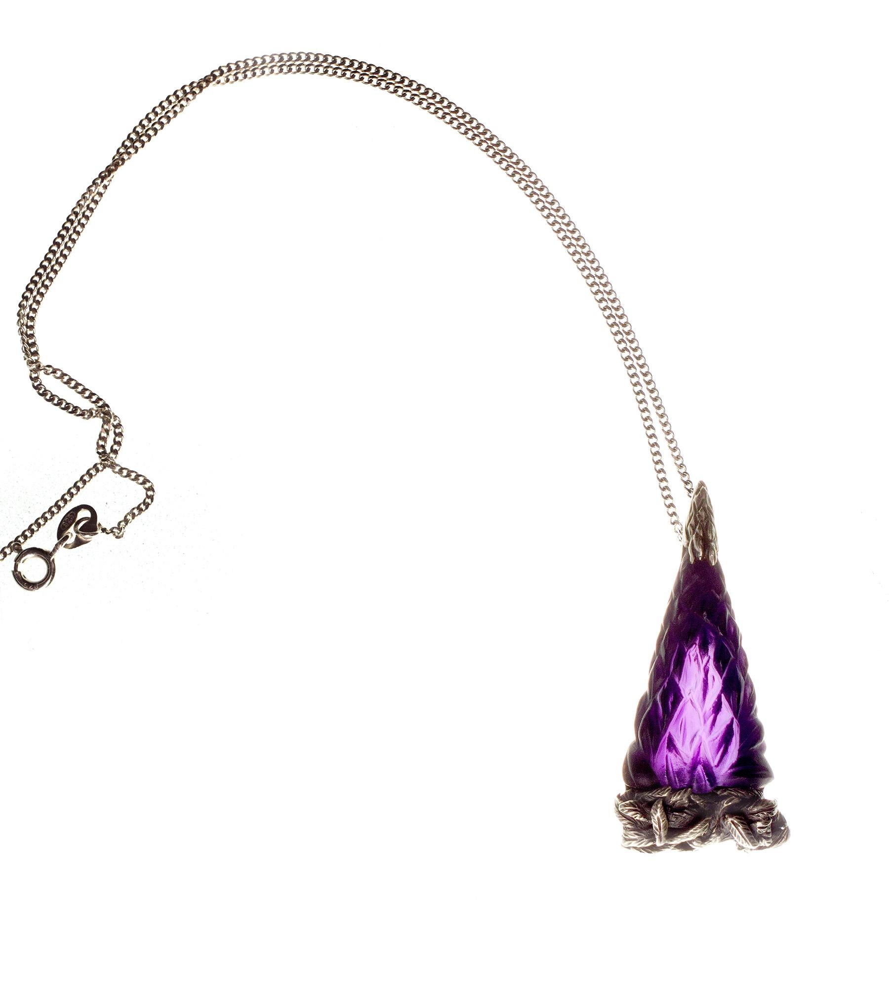 This Lupine pendant is an homage and our love letter to the brightest star, incomparable René Lalique. 

The jewel is made with cut purple amethyst in the shape of lupine buds. This designer pendant in dark silver looks a little bit gothic and