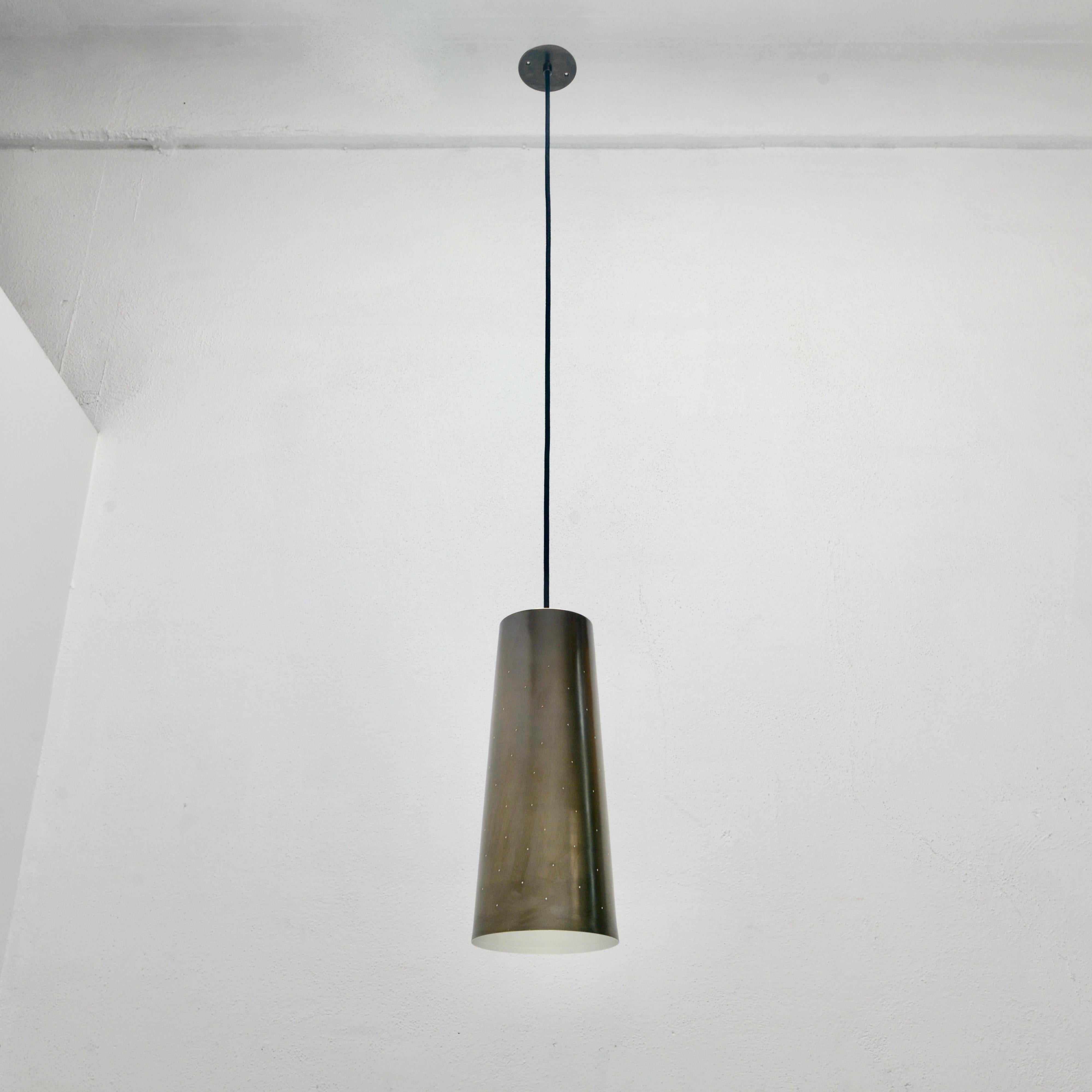 Fabulous large LUrco brass pendant with perforations. Made of solid brass. Interior is an off white painted finish and the exterior is un-lacquered patinated brass. Has a single medium based socket 100 watts maximum. OAD adjustable on site. Includes
