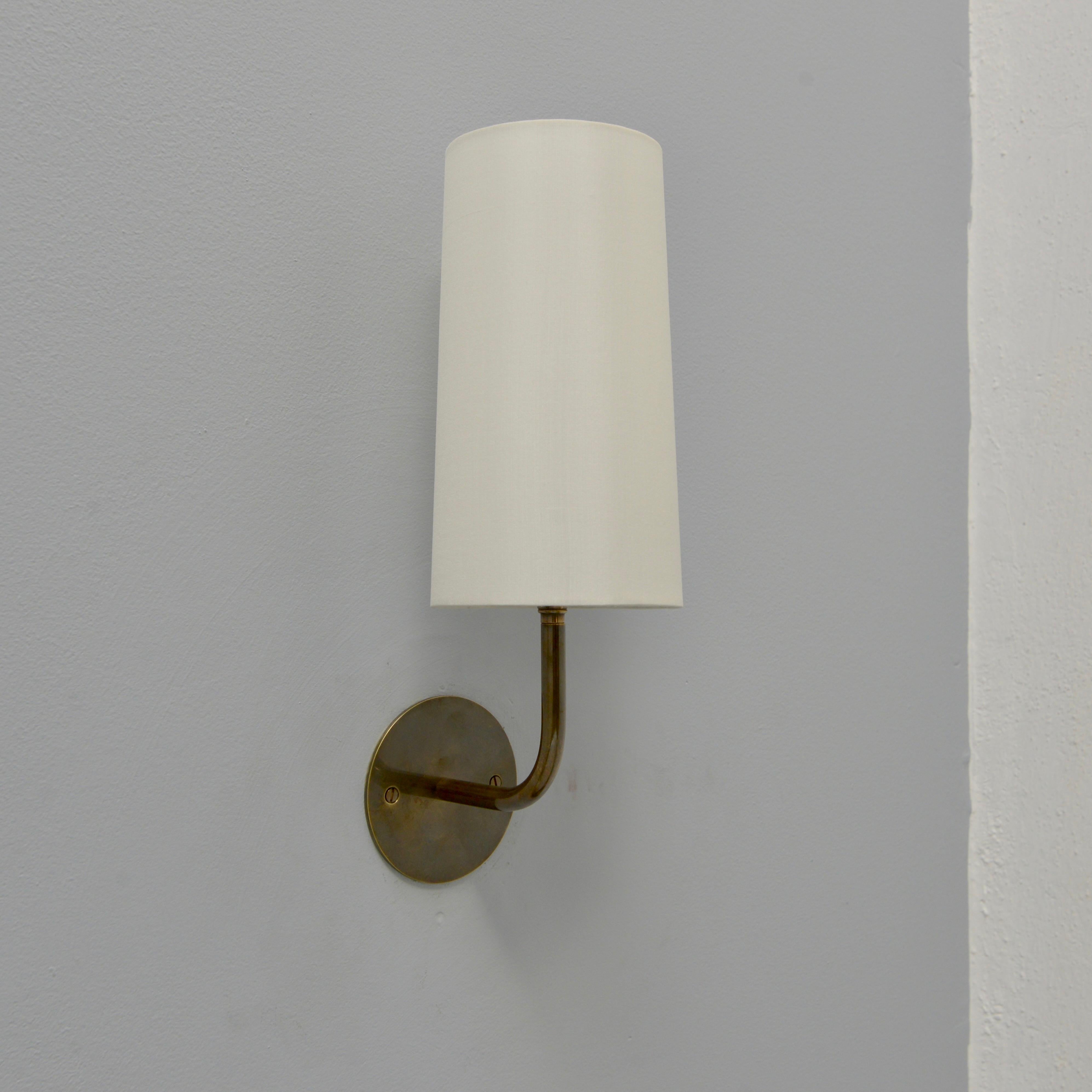 The elegant LUroy Sconce by Lumfardo Luminaires is a French inspired wall sconce in brass with fabric shade. The brass in finished in an unlacquered lightly patinated brass. This sconce is made in the USA and is part of our contemporary collection.